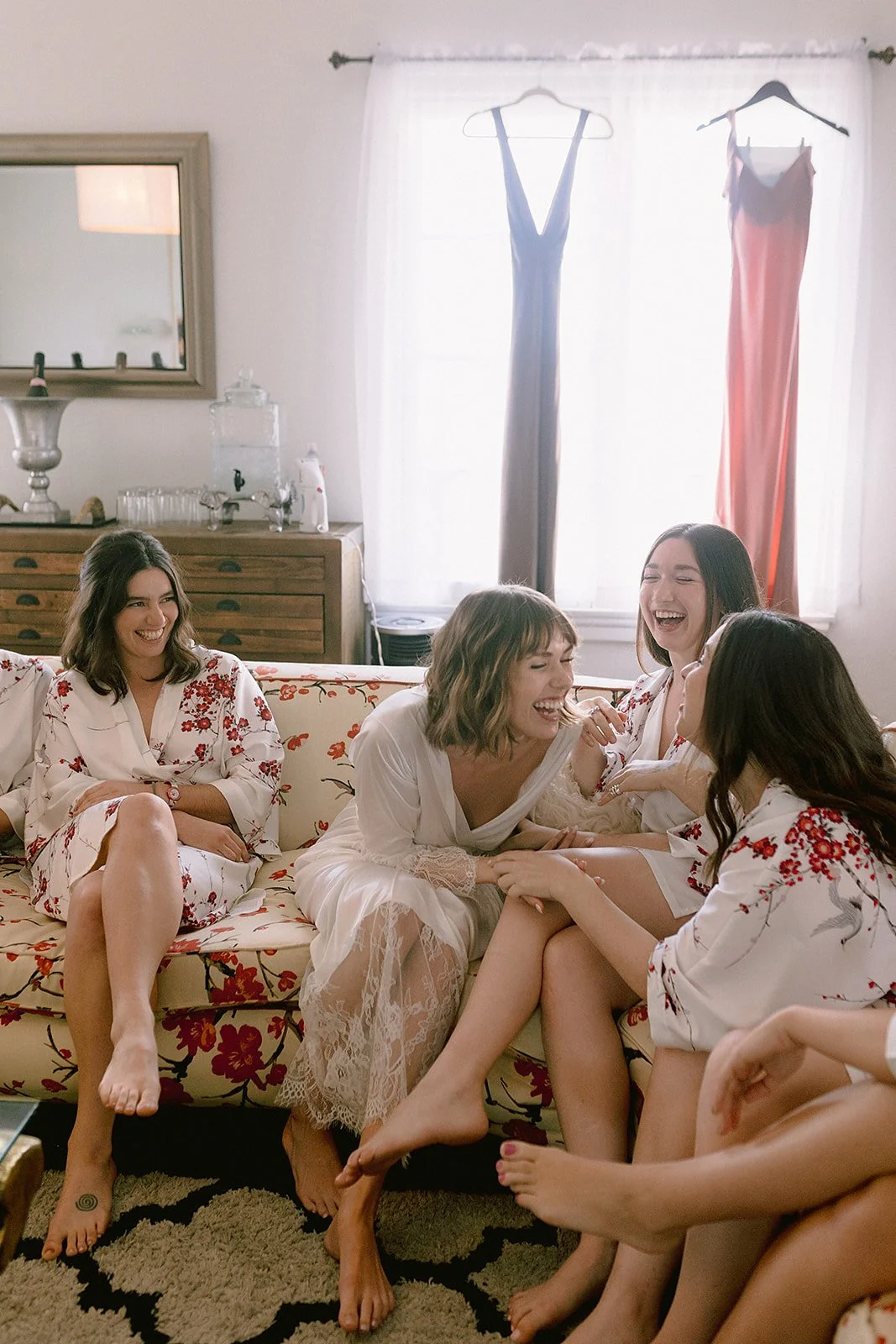 Bride and bridesmaids gathered around during hair and makeup, getting glammed for the wedding day in long beach