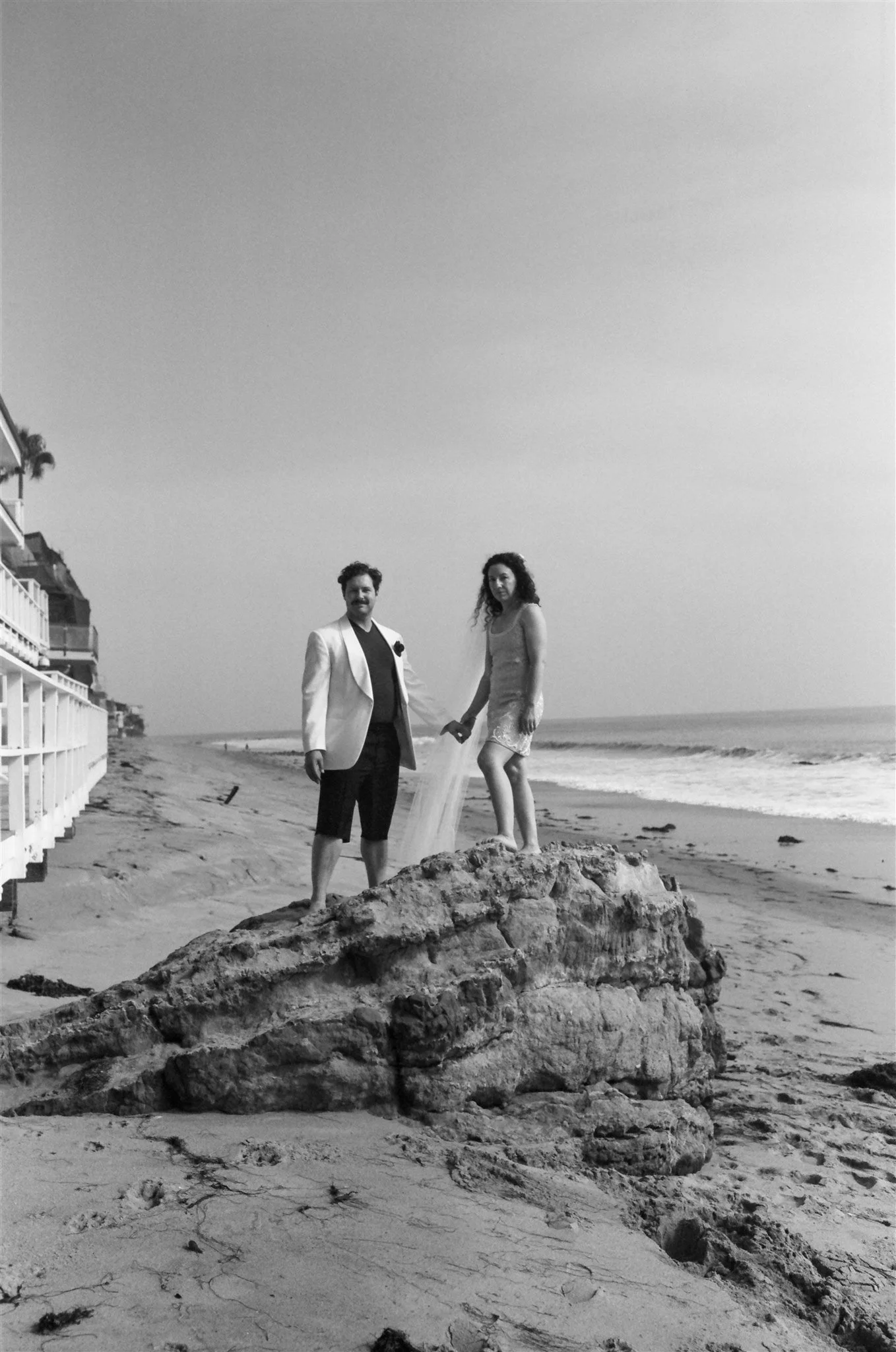 couple takes film photos on wedding weekend on the coast in malibu