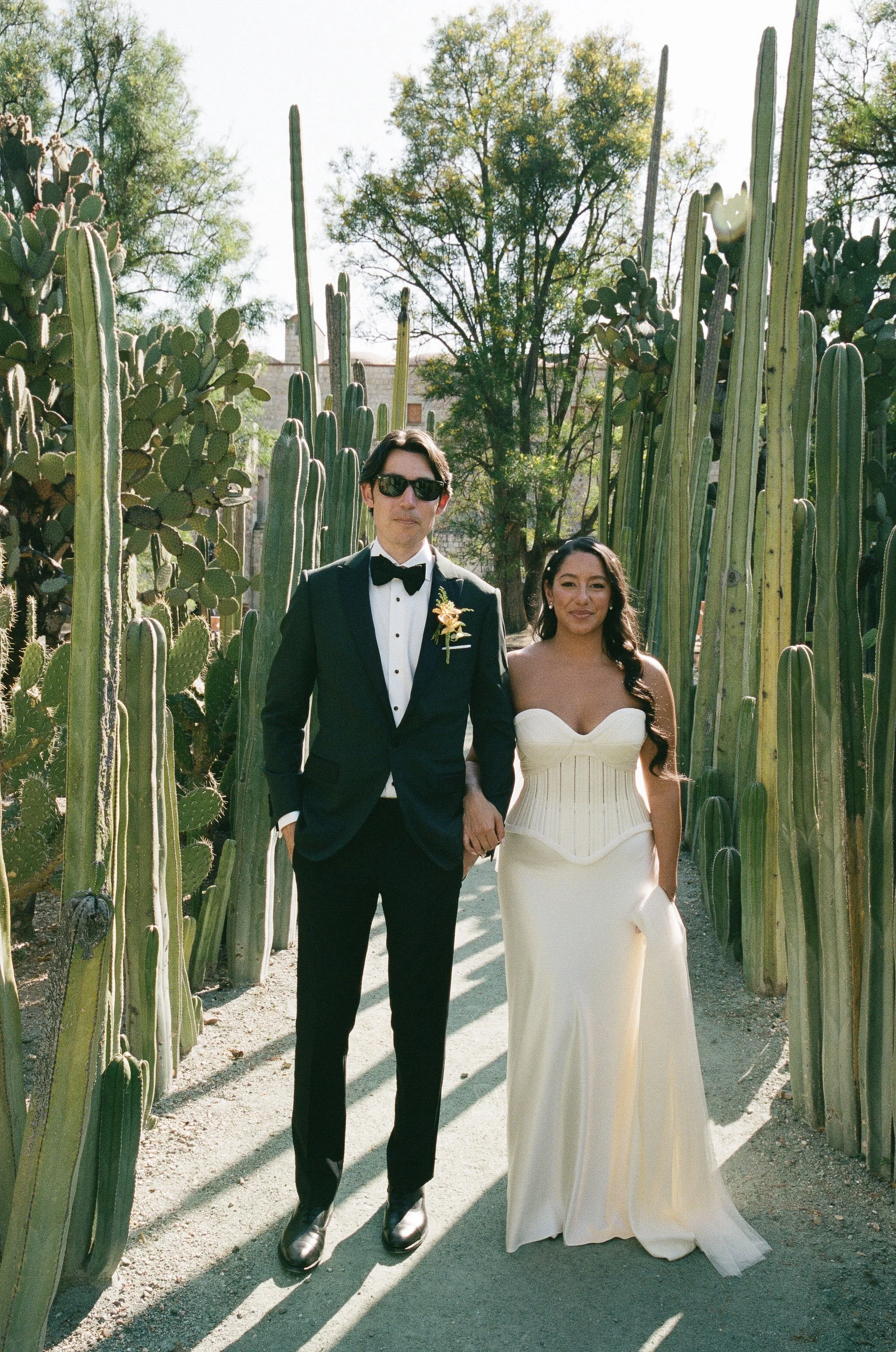 Destination Wedding in Oaxaca, mexico showcases bride and groom among the desert garden