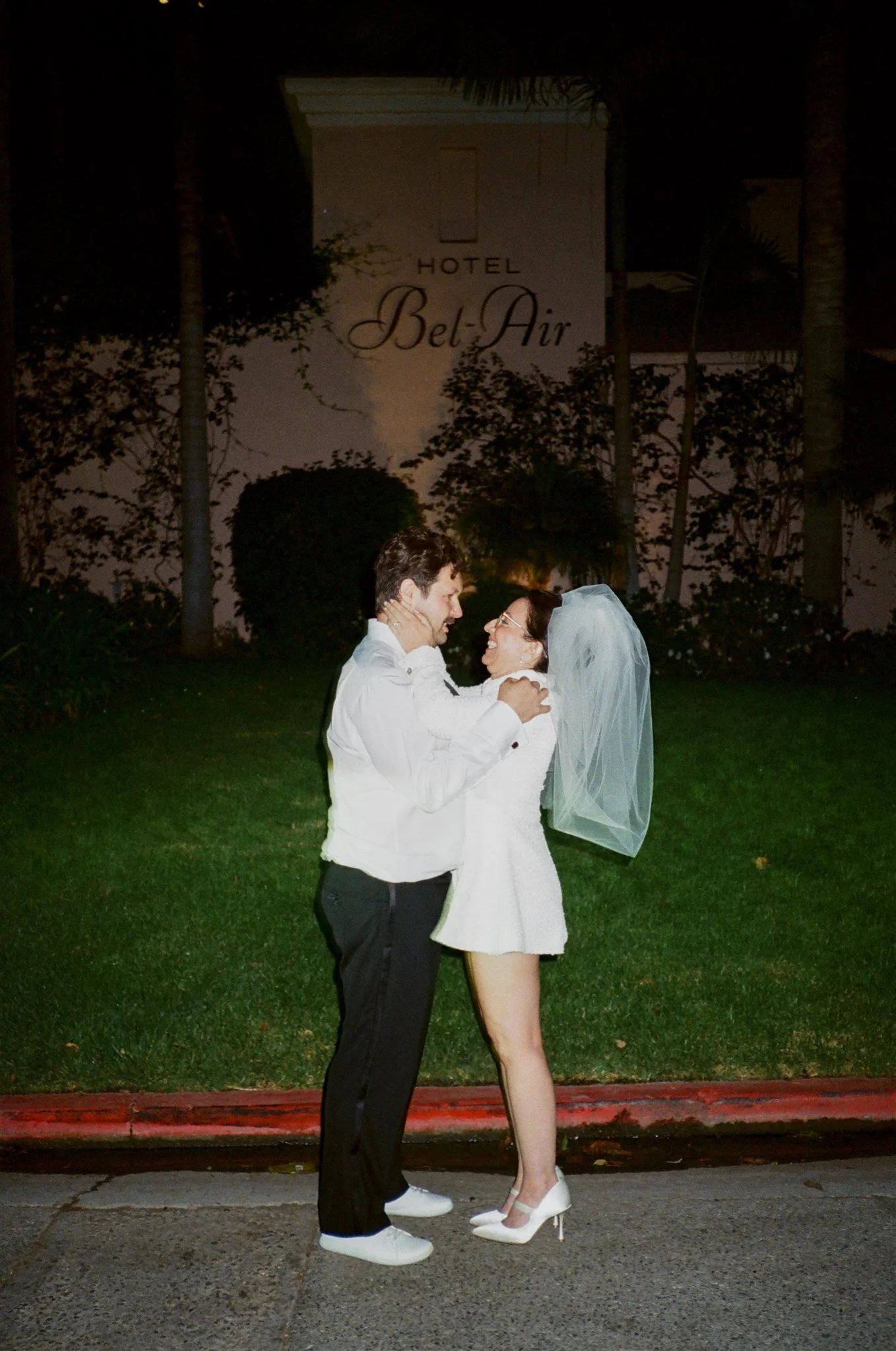 bride and groom elope and take photos outside of hotel bel air