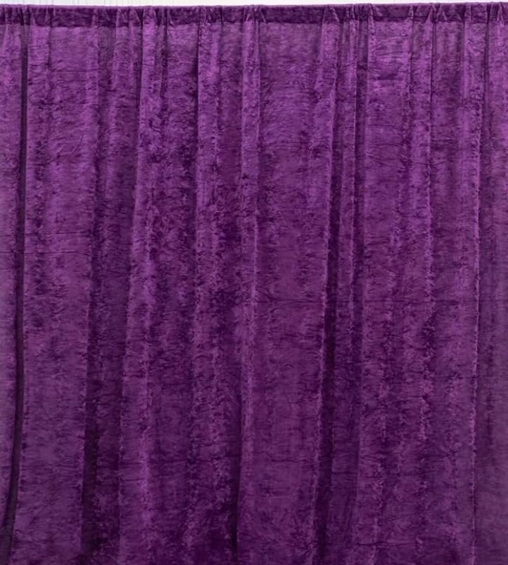 Purple velvet curtain with vertical pleats.