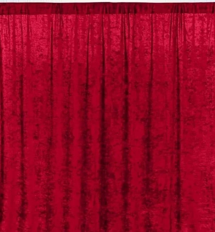 Red stage curtain with vertical folds.