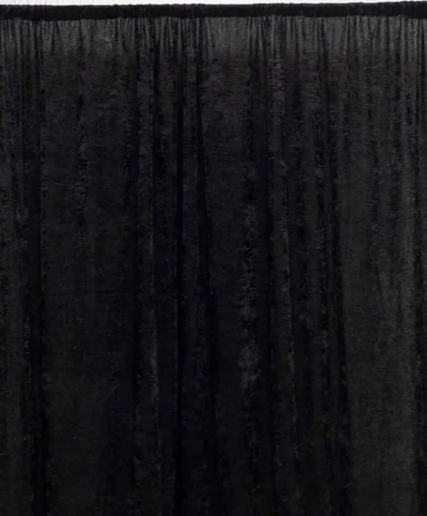 Black curtain hanging from a rod.