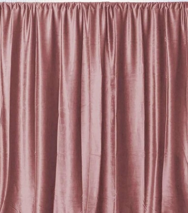 Pink velvet curtain hanging with pleats.