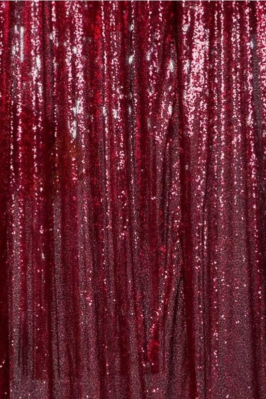 Close-up of a shimmering red curtain with sequins or glitter.