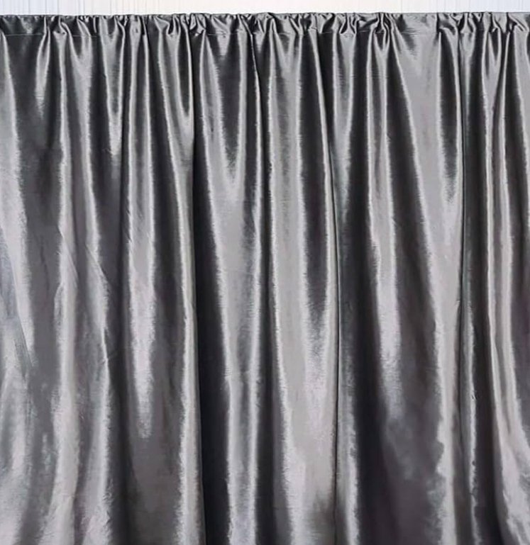 Gray satin curtain hanging with pleats.