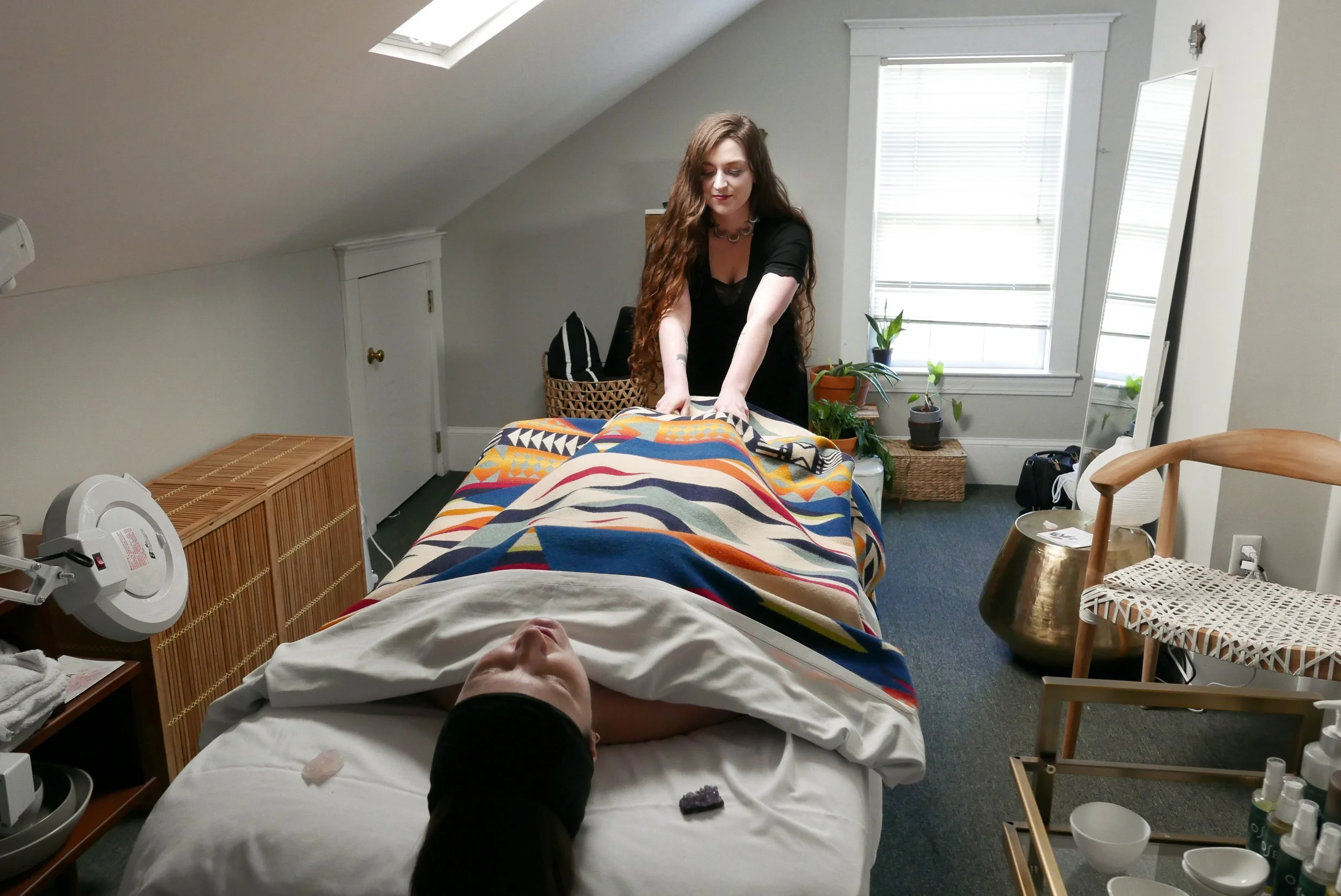 Massage therapist performing a massage treatment at Water House Wellness.