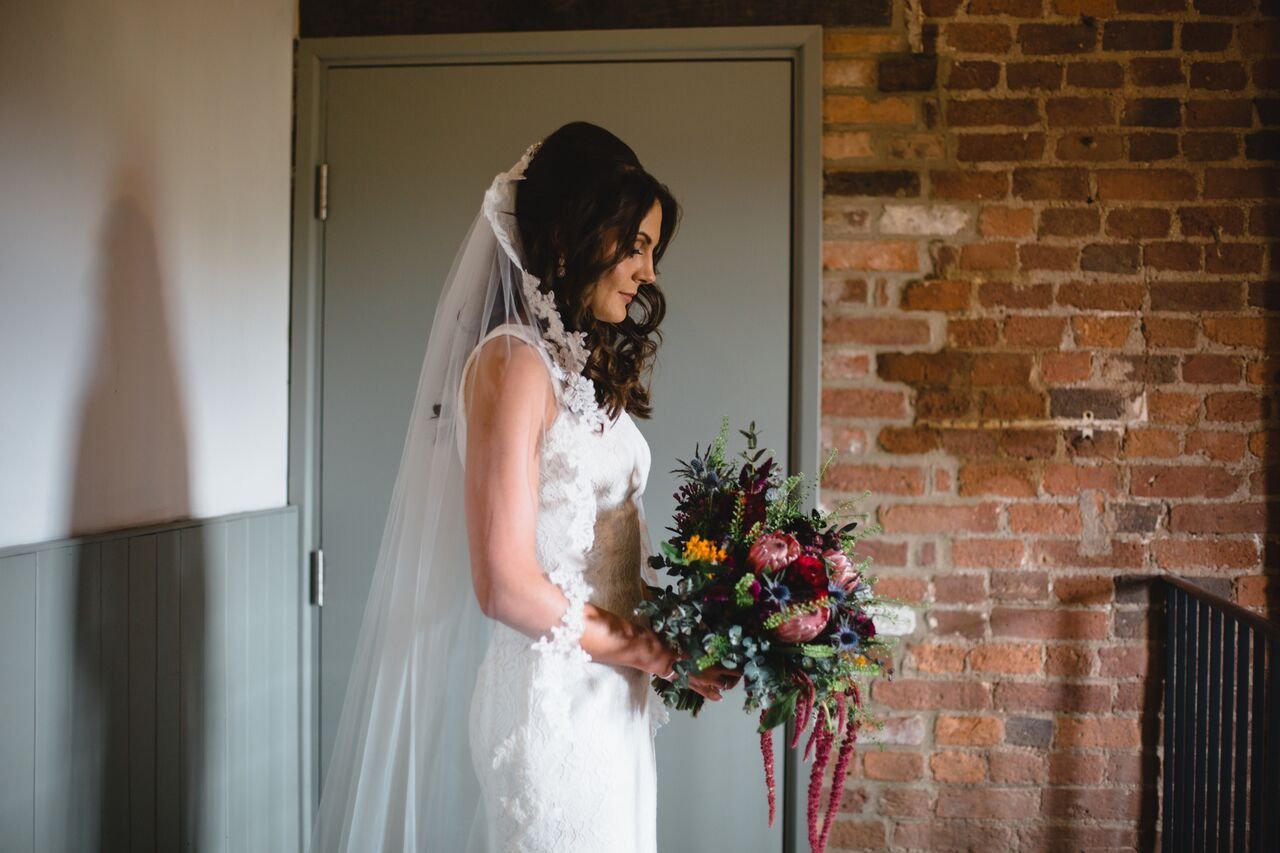 Bridal+bouquet+in+rich+jewel+colours+with+proteas_.jpg
