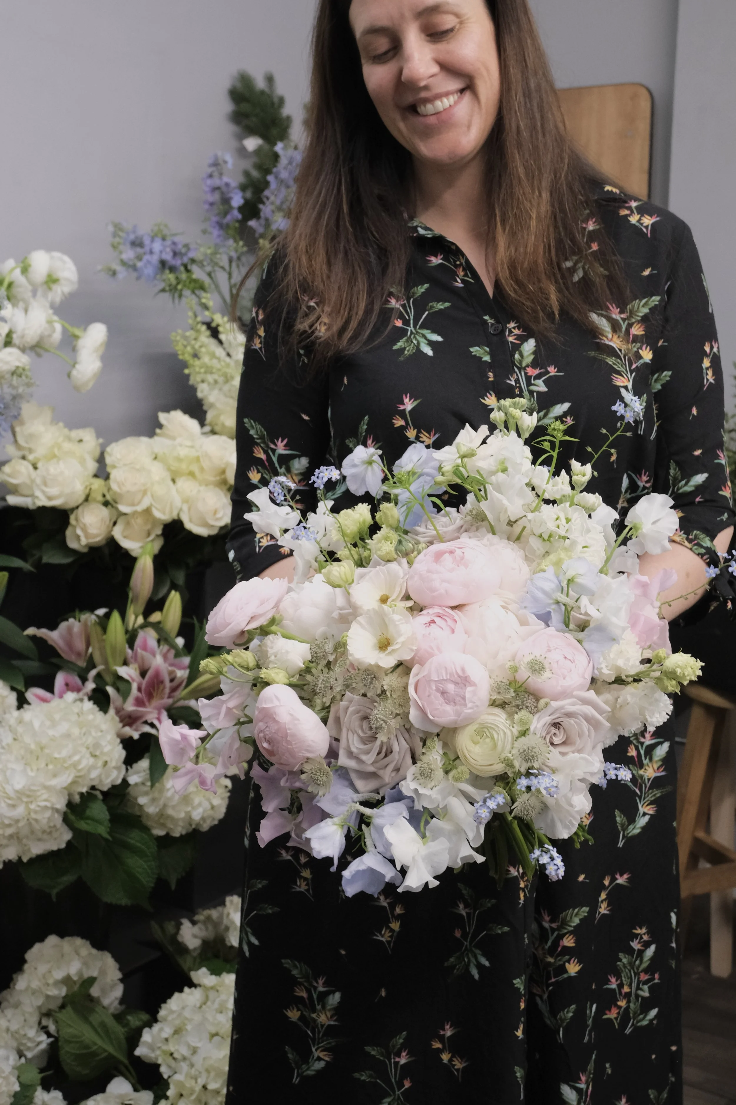 Flower bouquets in mansfield - florist holding a bouquet of pastel flowers in studio in mansfield