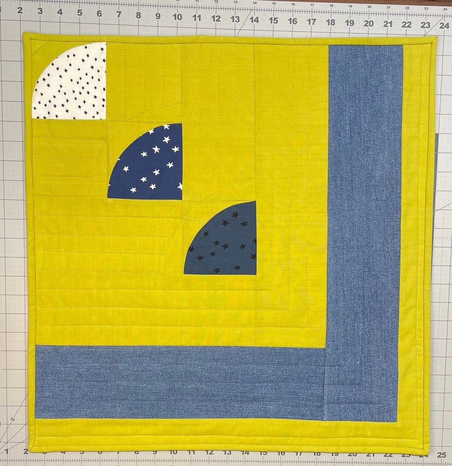 Add a modern twist to your living area or bedroom with this bold quilted wall hanging! ⁣
⁣
Minimalist design, handmade from 100% cotton and upcycled denim.  The star print fabrics bring a touch of whimsy, and the near-chartreuse background will brigh