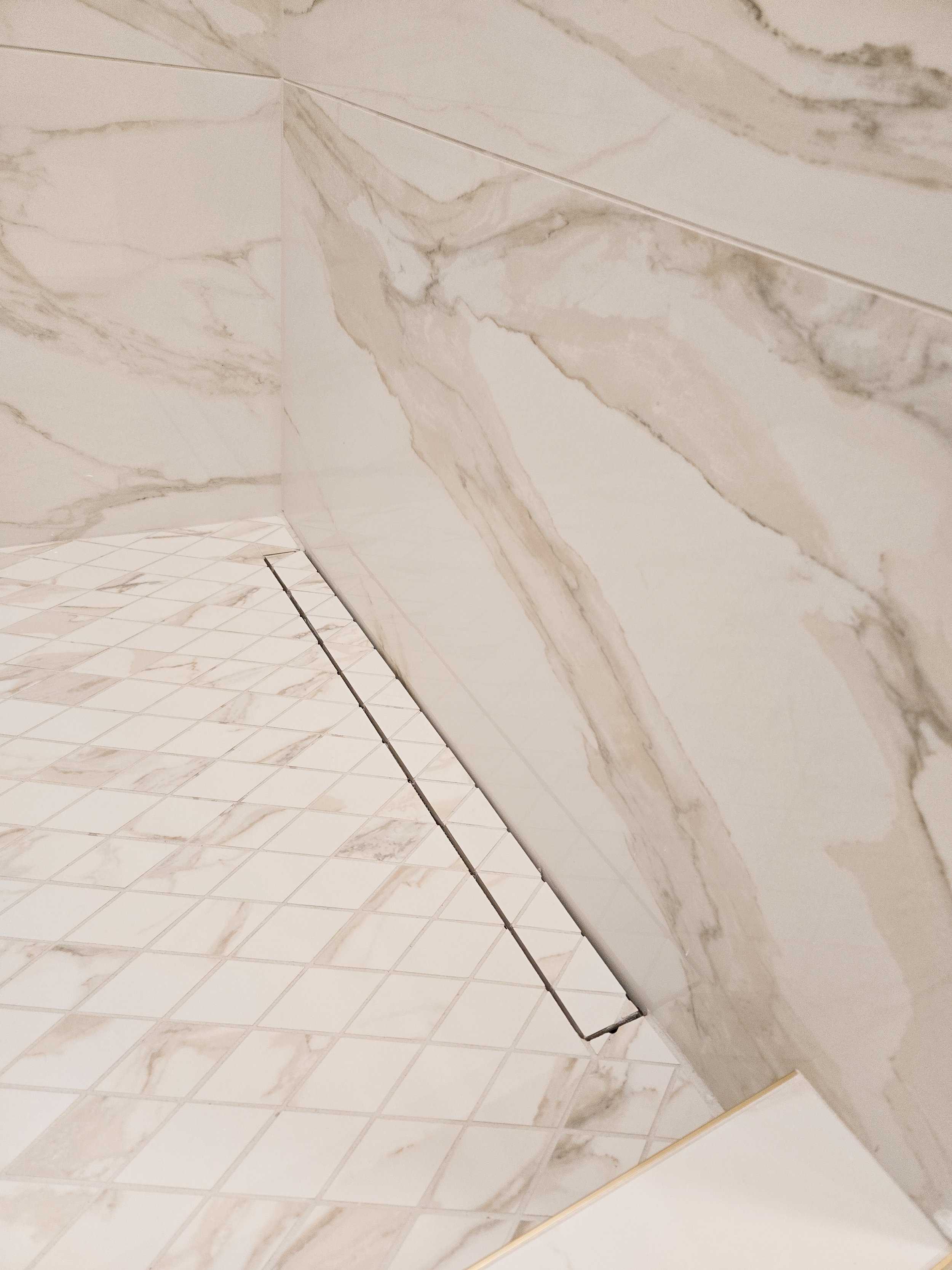 Modern linear drain in tiled shower installed in Wisconsin Dells.