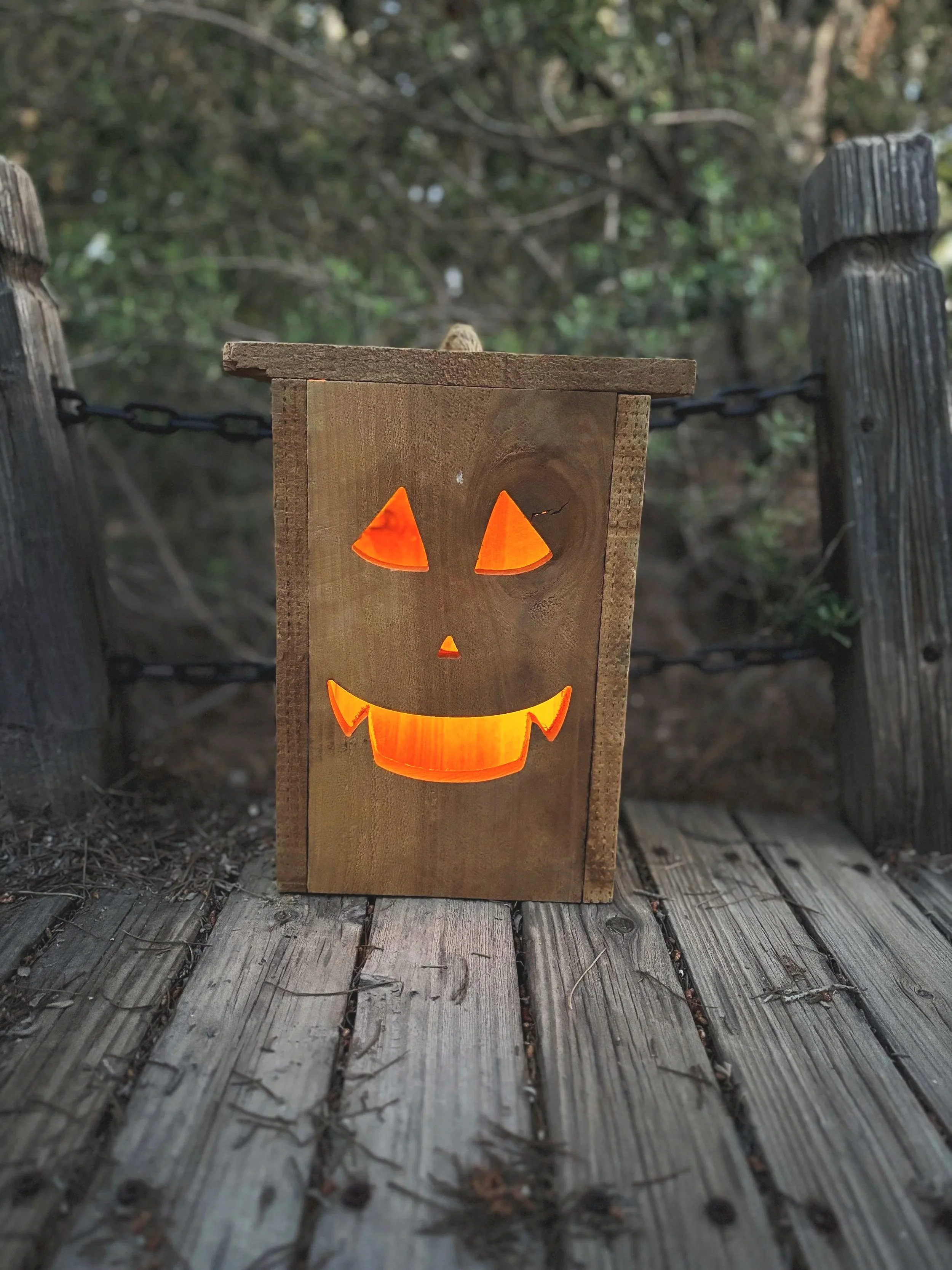 Customized cedar wood Halloween lantern named Fang Jr, handmade rustic outdoor holiday decor with atmospheric orange glow.