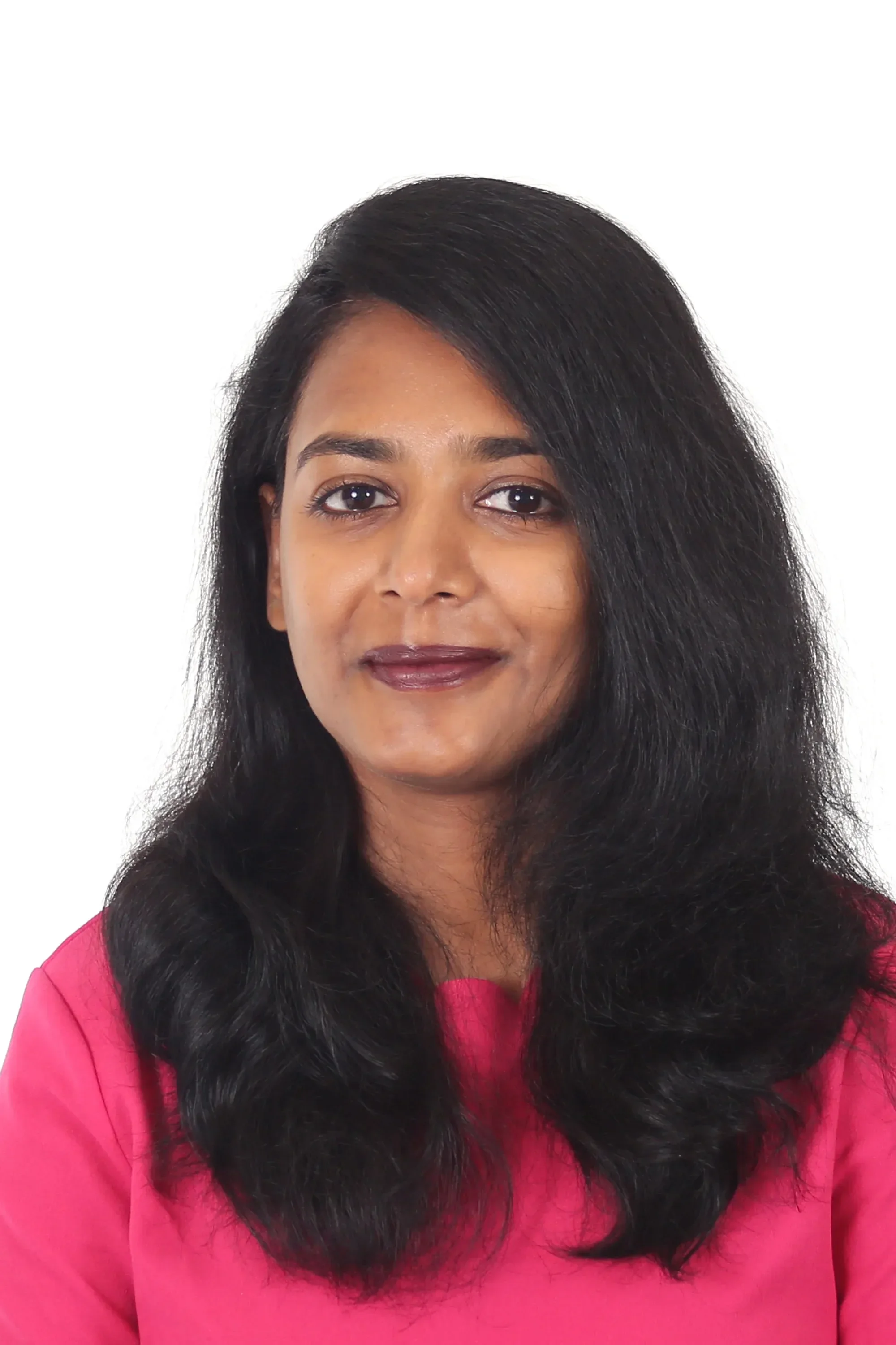 Close-up portrait of a young woman with dark straight hair, wearing a pink shirt, white background