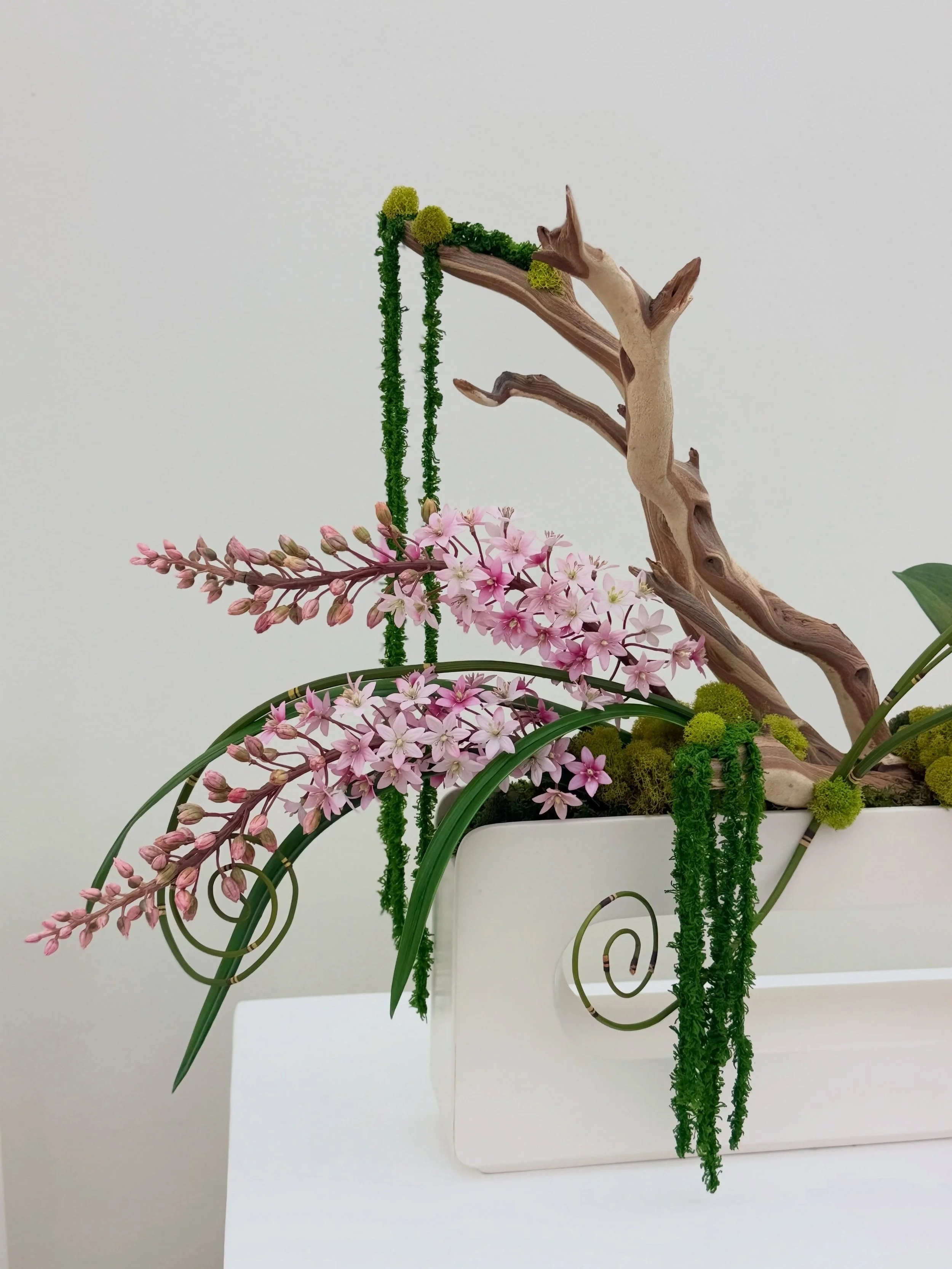 Custom designed for a luxury estate, this one-of-a-kind orchid arrangement blends sculptural wood, cascading phalaenopsis orchids, and organic textures into a true statement piece. Every design is handcrafted to complement the home it was created for