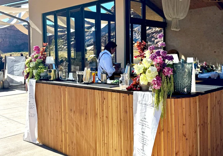 A bartender pouring at an outdoor bar