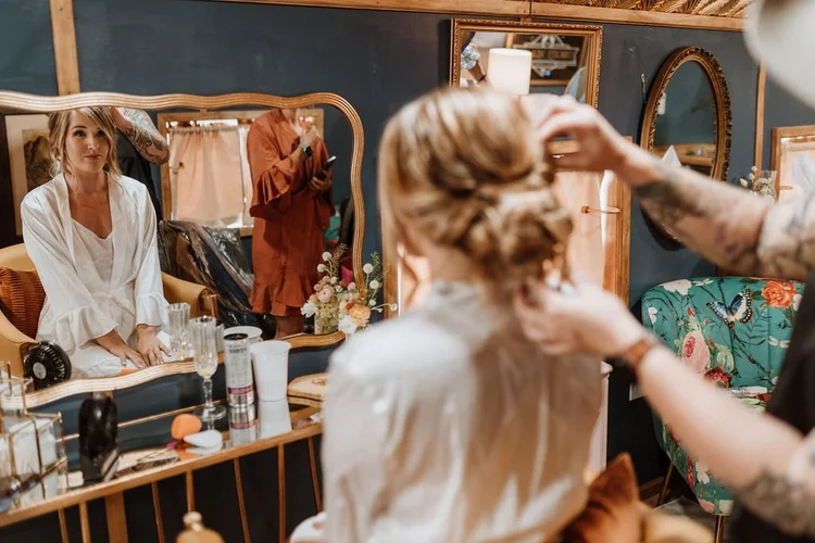 A bride being styled at the bridal suite