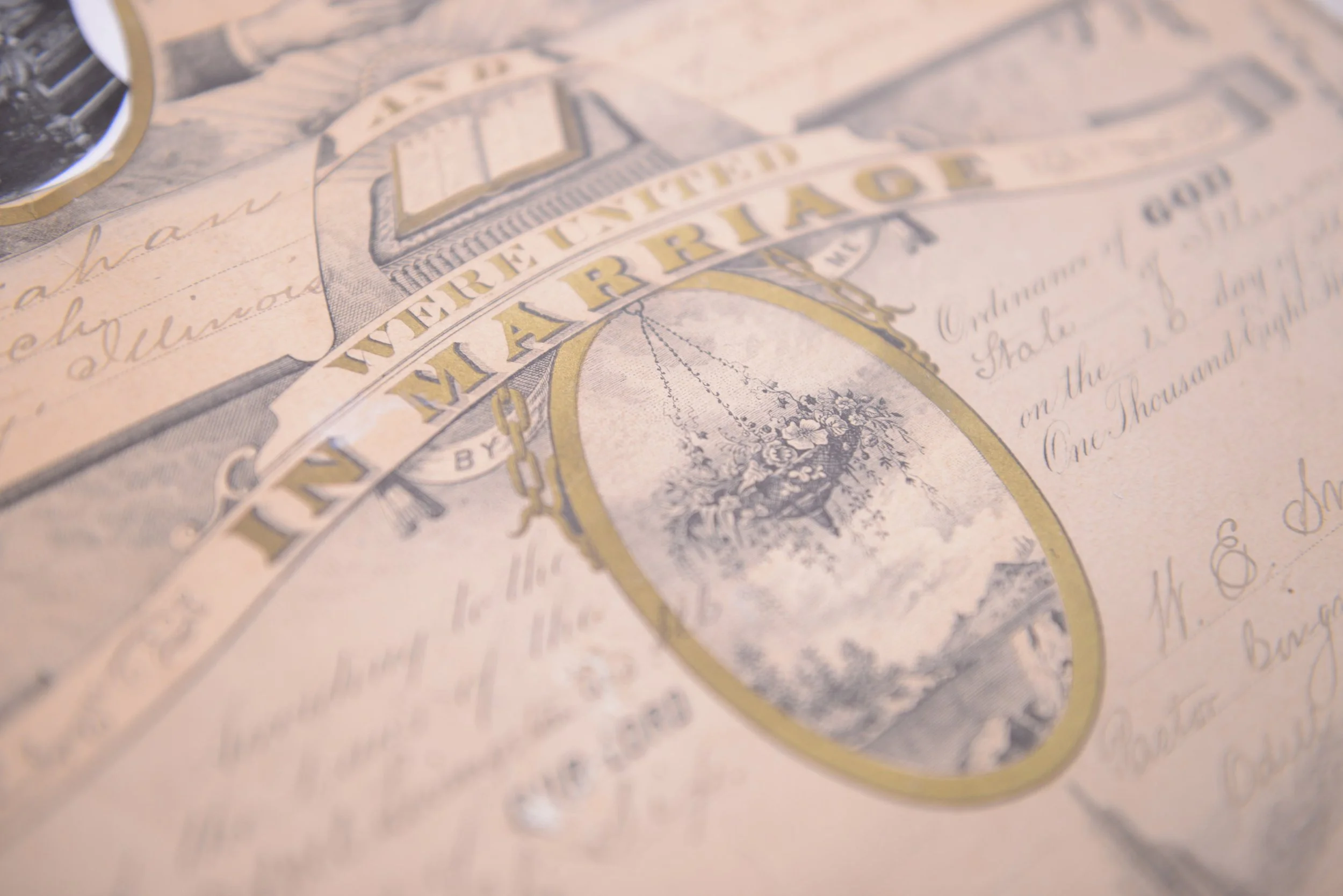 Close-up of a vintage paper document with intricate lettering and a circular emblem, possibly a currency or historical certificate.