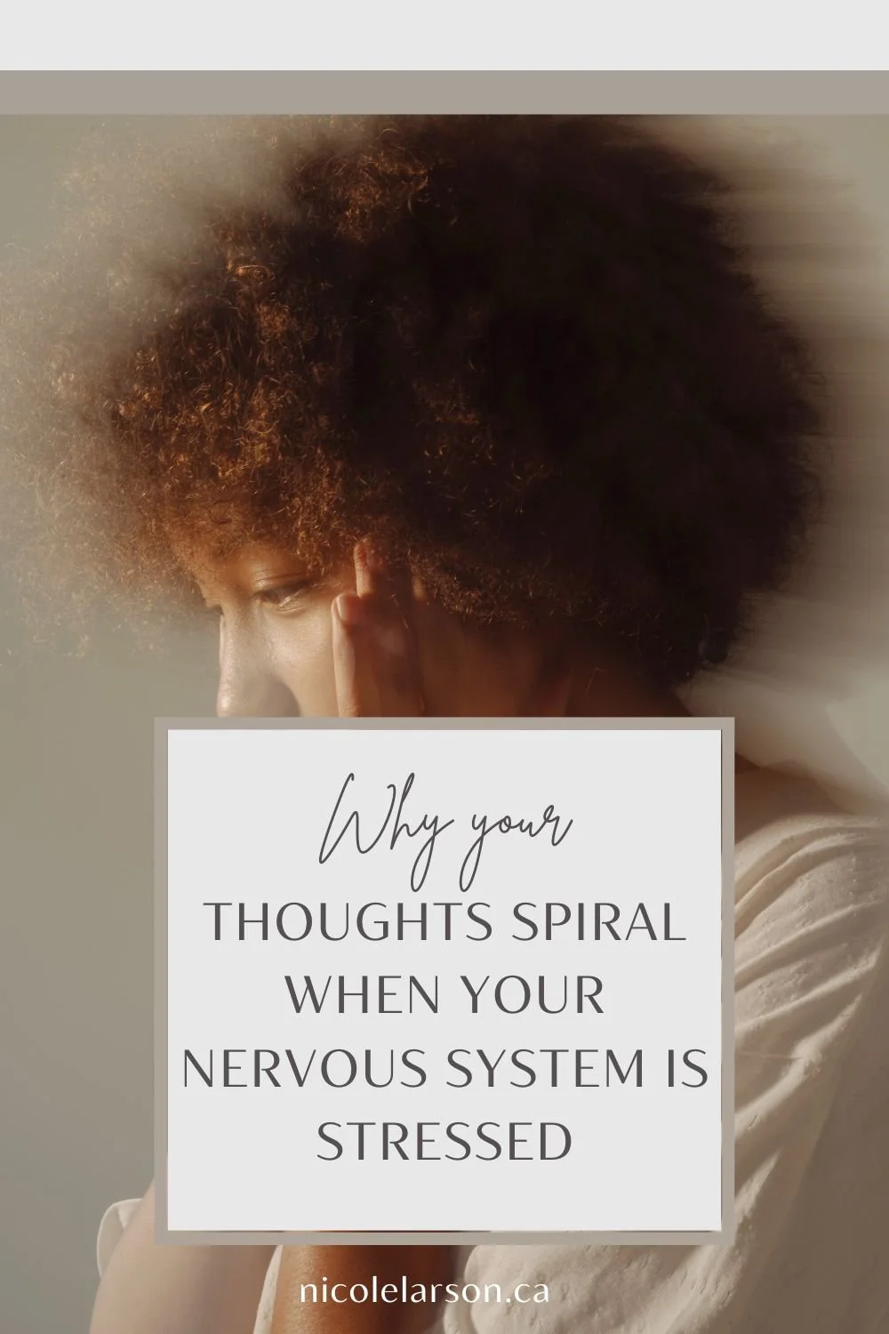 A soft image of a woman holding her head and looking stressed.