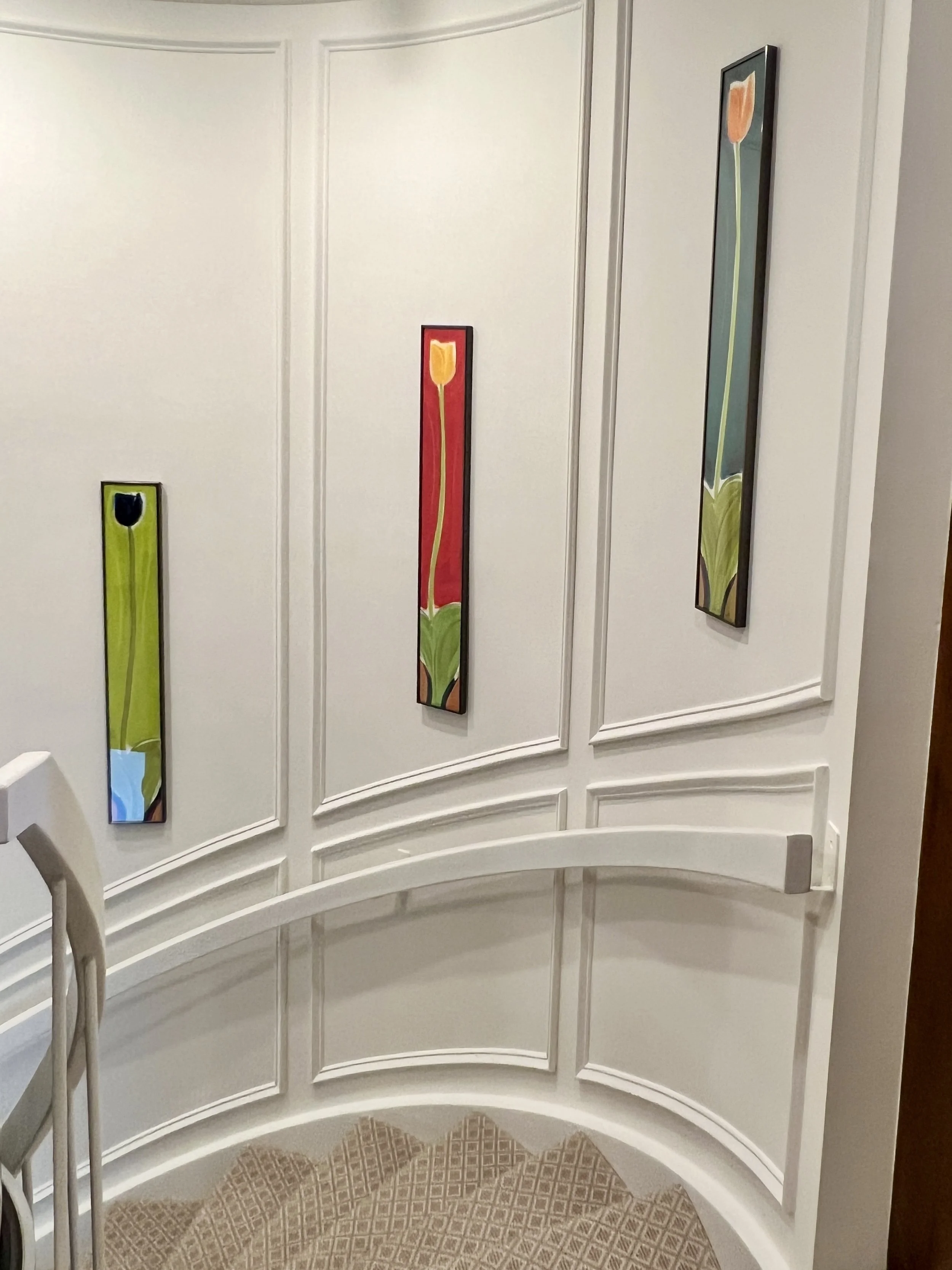Removing dark wallpaper and adding custom wall moldings to support their existing art -made this entryway stairwell better than they could have imagined. 