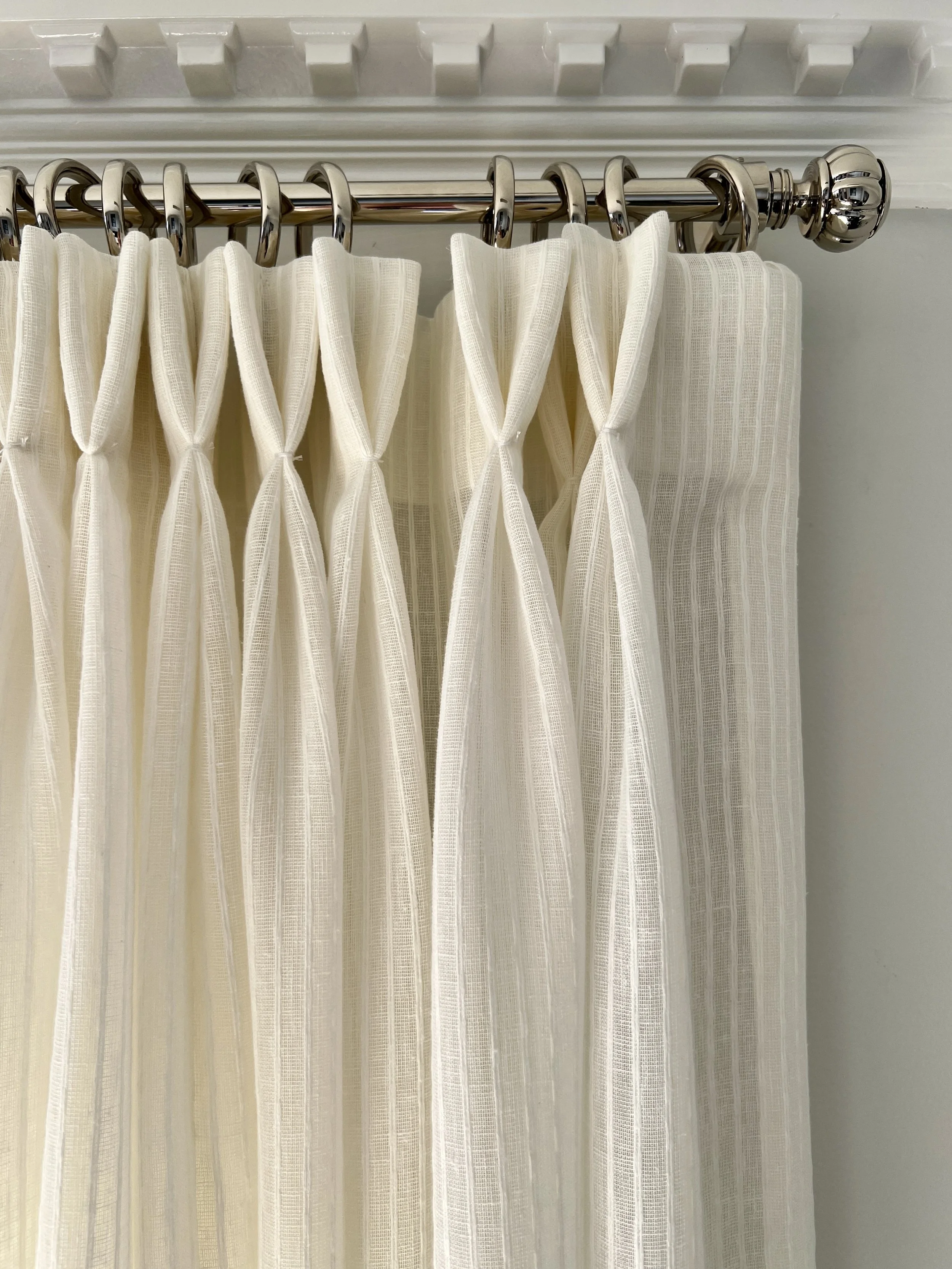 Subtle textured linen drapery with custom sun shades.