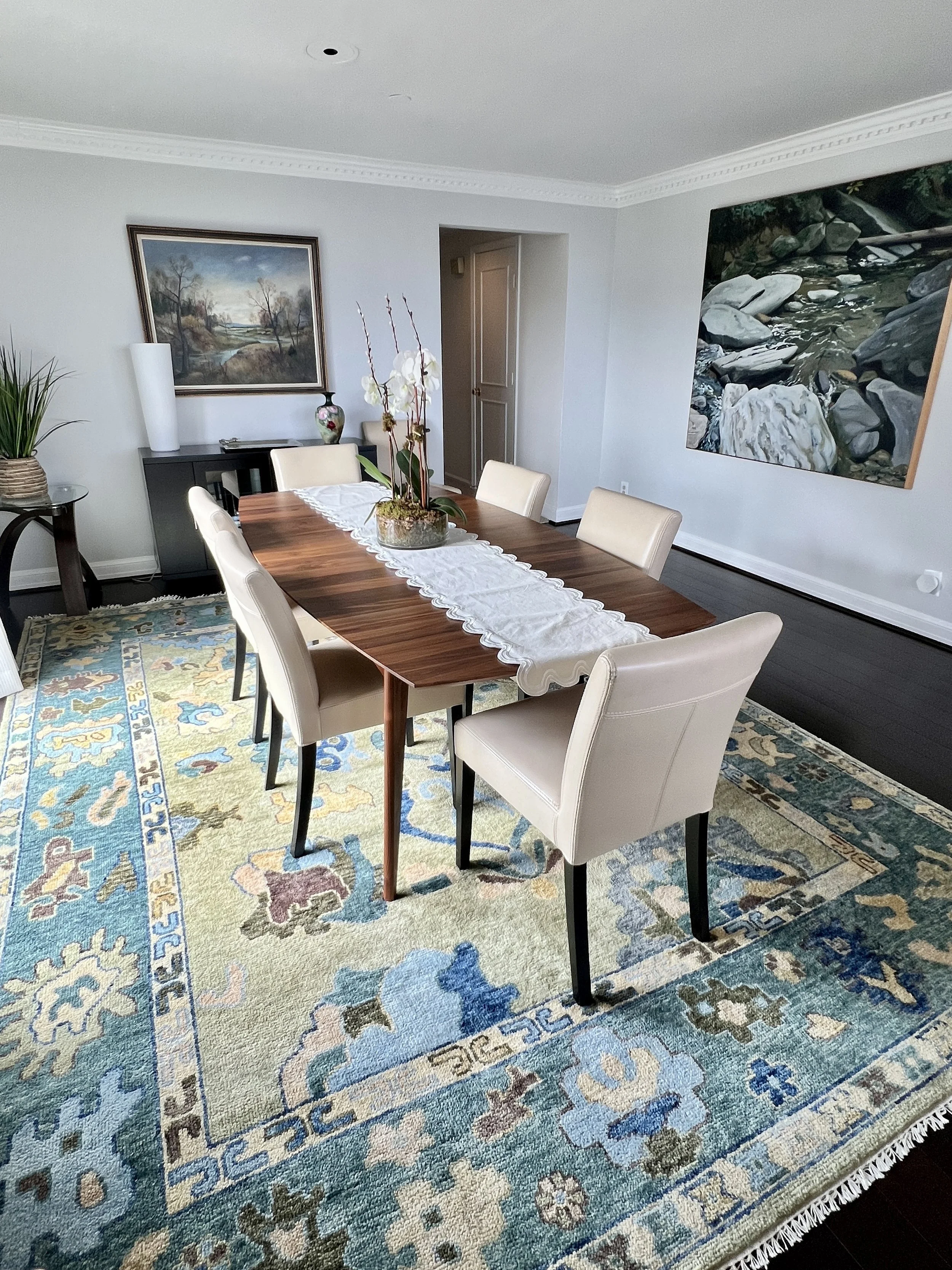 The soft palette of this room needed contrast and color to ground the space. A hand selected rug of earthy blues and greens pulls the whole space together. 