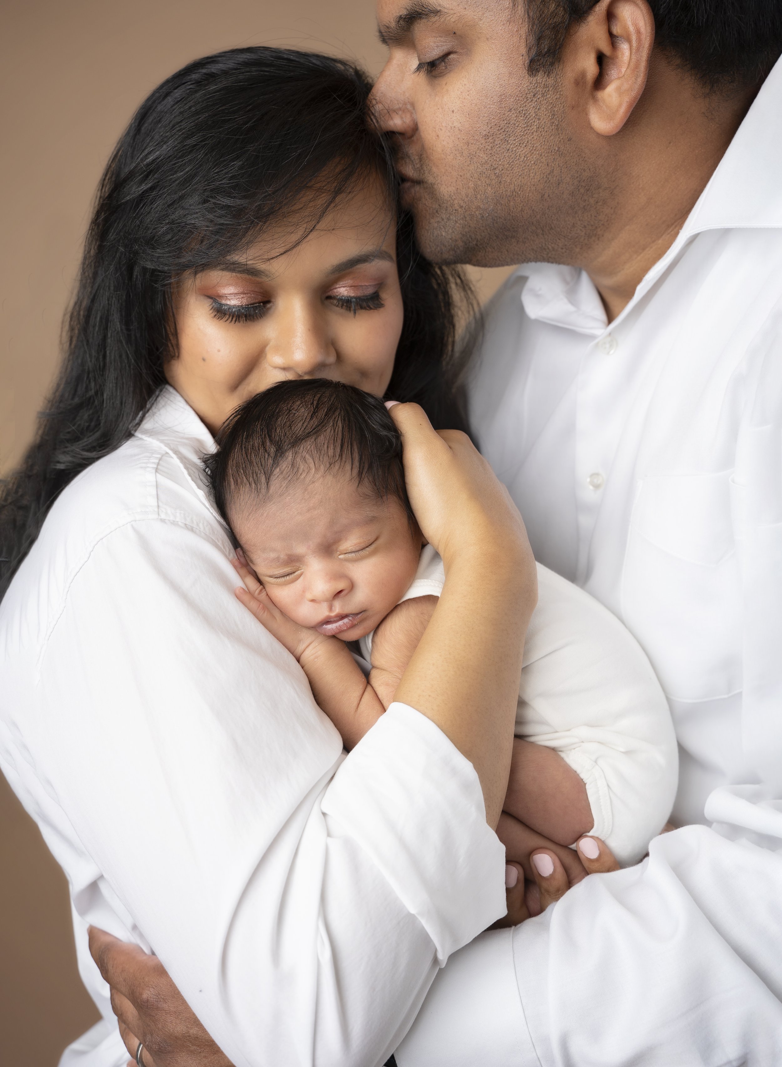 Mom kissing newborn baby boy