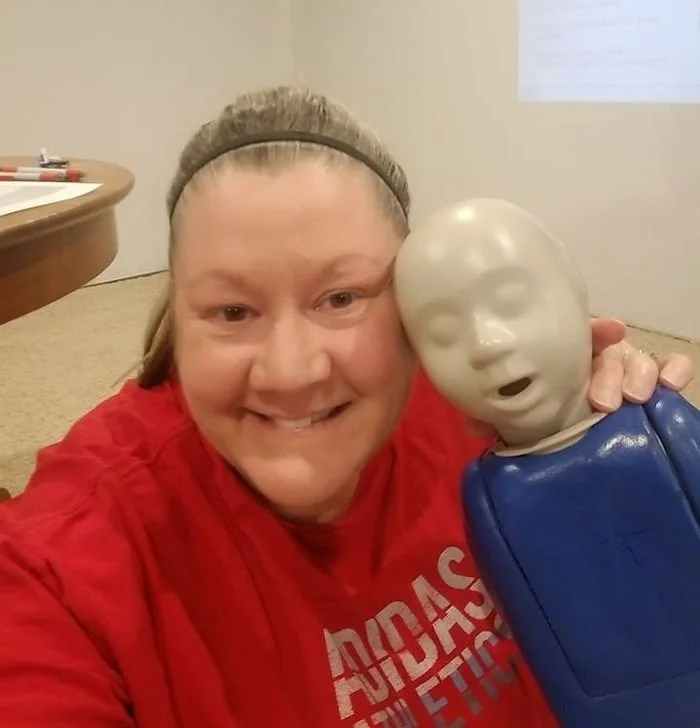 Omaha Photographer with the baby doll at infant certification