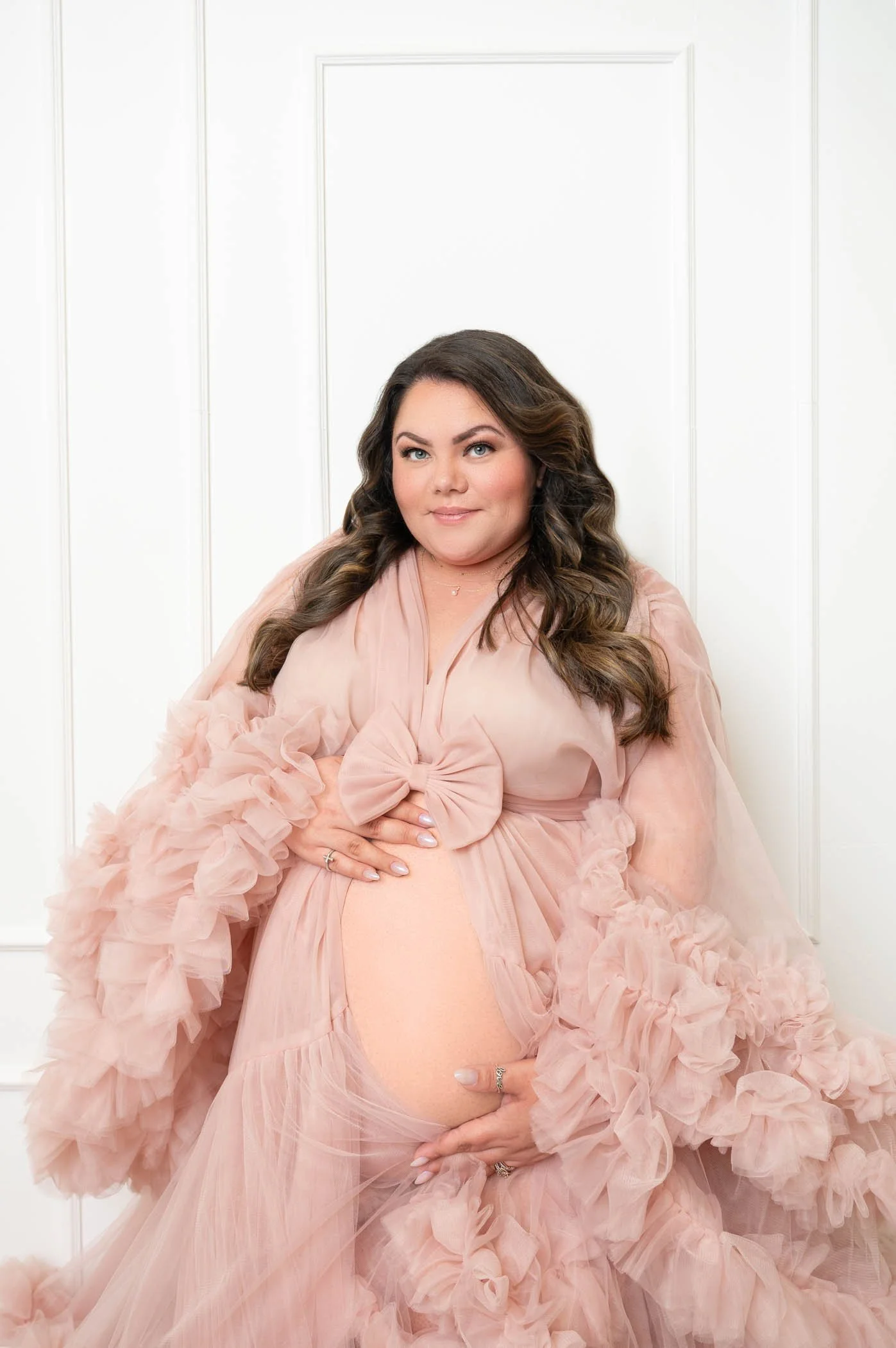 maternity session in houston studio with pink fluffy dress