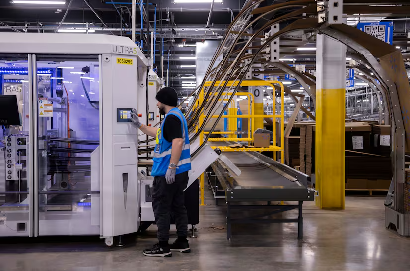  A worker controls a box-making machine inside of Walmart’s new online fulfillment center in Lancaster. The center has capacity to ship twice as many orders than a regular one.(Juan Figueroa) 