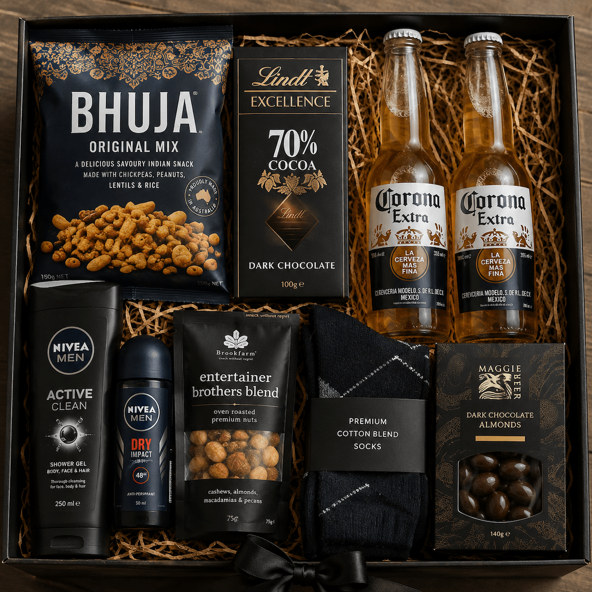 Gift hamper for a man with beer, and assorted sweet and savoury items with a body wash and body spray in a gift tray.