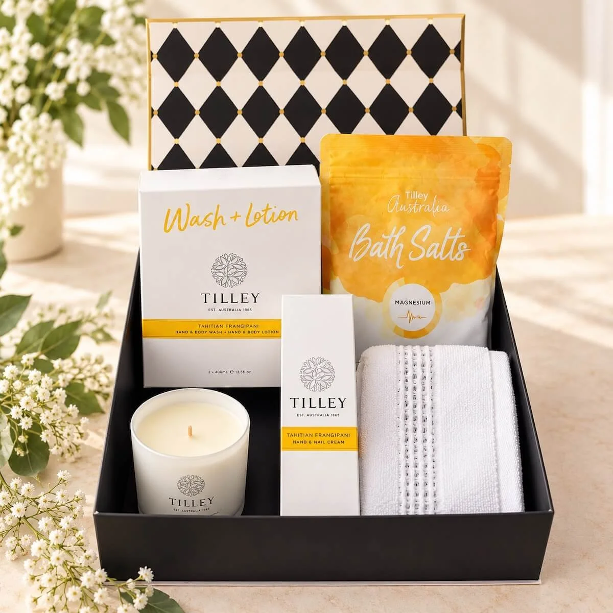 Luxury pamper gift hamper beautifully presented in an open gift box with Tilley bath products Body wash & Lot in a magnetic close gift box.