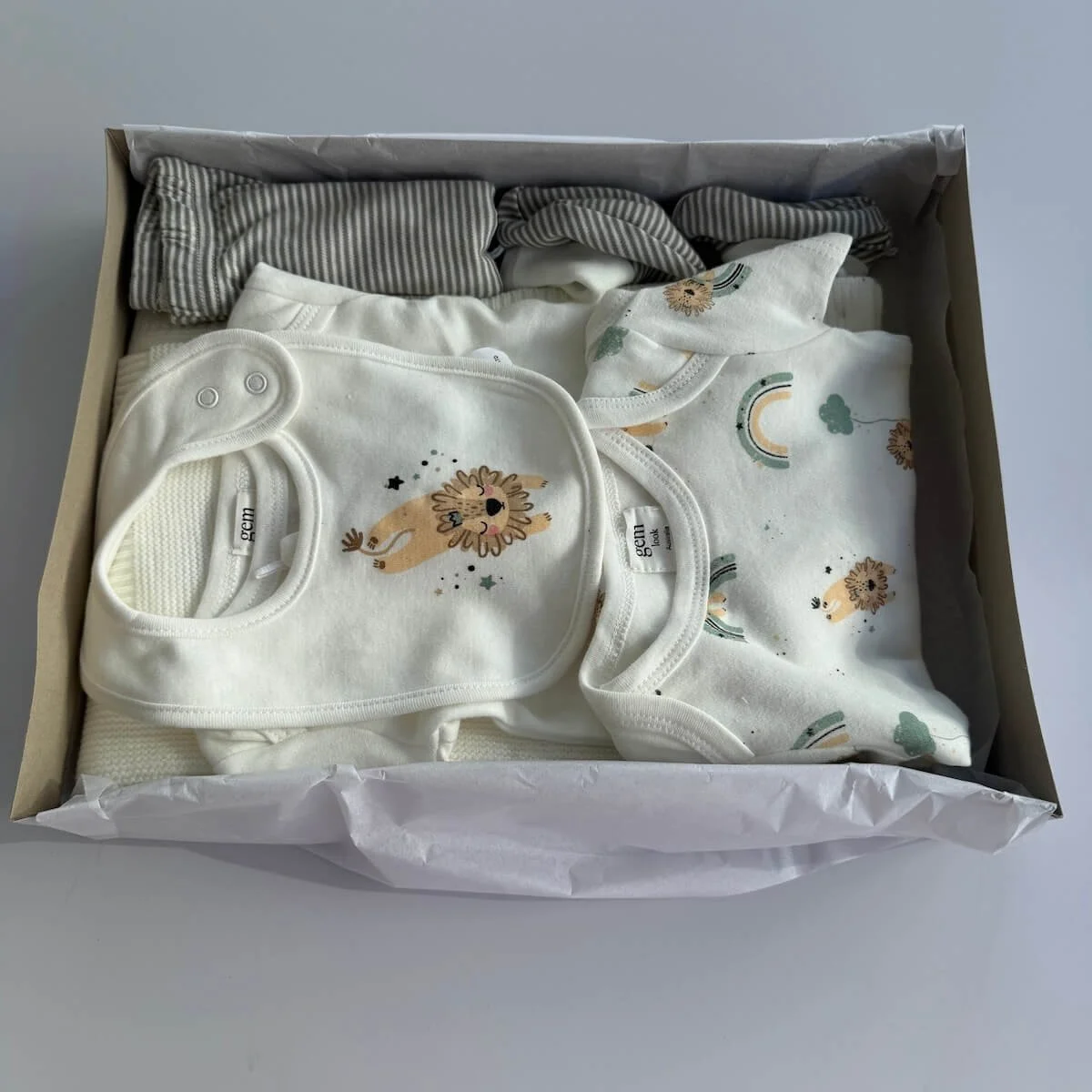 Open Love You to the Moon & Back Baby Gift Box showing knitted blanket, matching baby clothing set, and pram rattle toy neatly packed inside