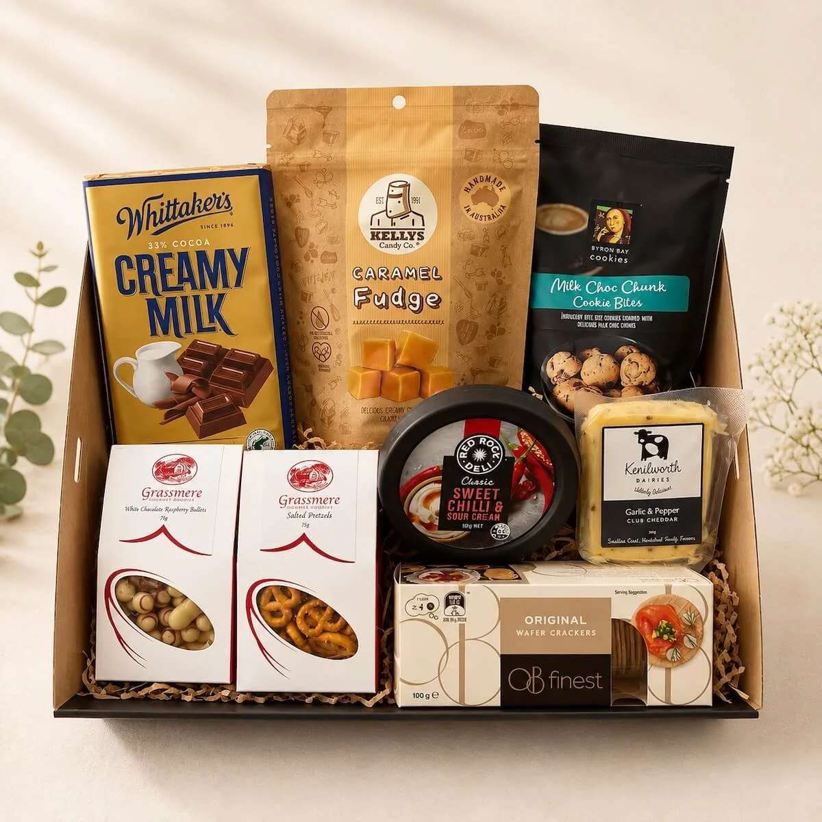 Guilty gourmet gift hamper with fudge, chocolates, cookies, pretzels, raspberry bullets, cheese, cracker and a savoury dip for Gold Coast Delivery.