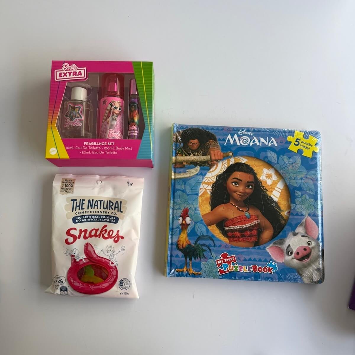 Disney Moana puzzle book with five fun puzzles, bag of lollies and body spray pack, designed for children aged 6 years and over.
