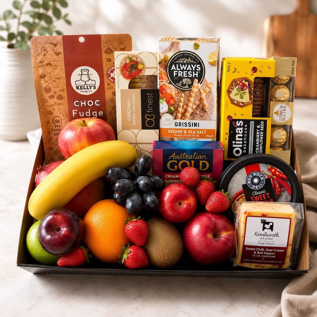 Fresh fruit and Lindt chocolate gift hamper with apples, grapes, strawberries, bananas, pears and seasonal fruit, available for Gold Coast deli
