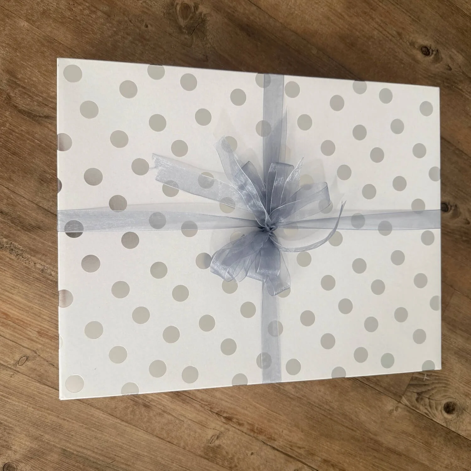 Love You to the Moon & Back Baby Gift Box in a closed wooden gift box, tied with ribbon and bow, ready to gift