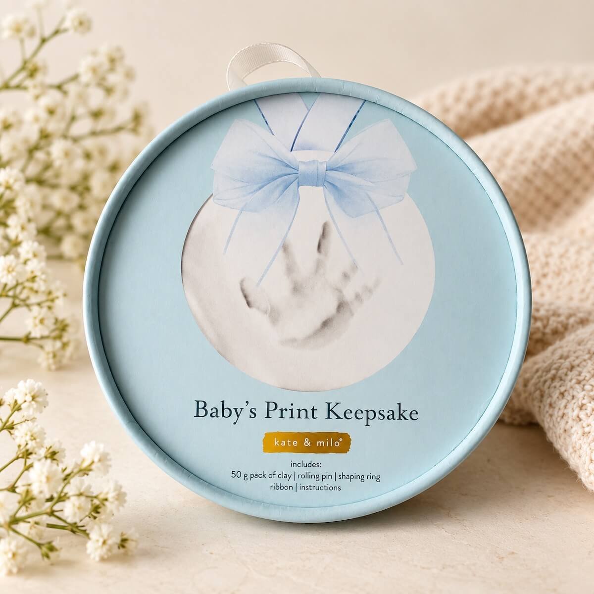 Kate & Milo Baby's Print Keepsake kit in a blue round gift box for creating a lasting baby handprint or footprint.
