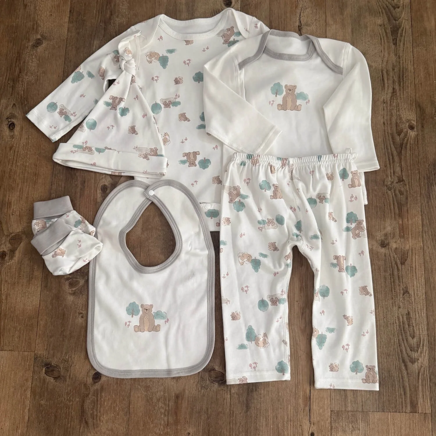 Animal-themed baby clothing set including top and pants, sleeveless bodysuit, hat, bib, and booties from the Sweet Dreams Baby Gift