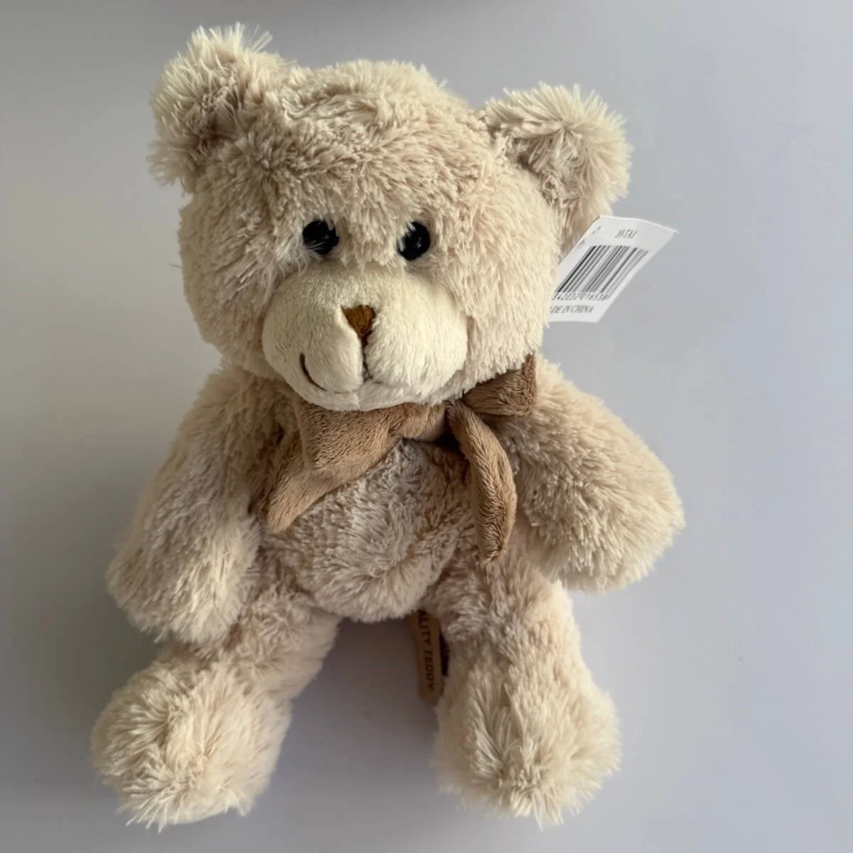 Tiny Treasure gift hamper has the teddy included which in approximatey 20 cm long soft and cute with a scarf around its neck.