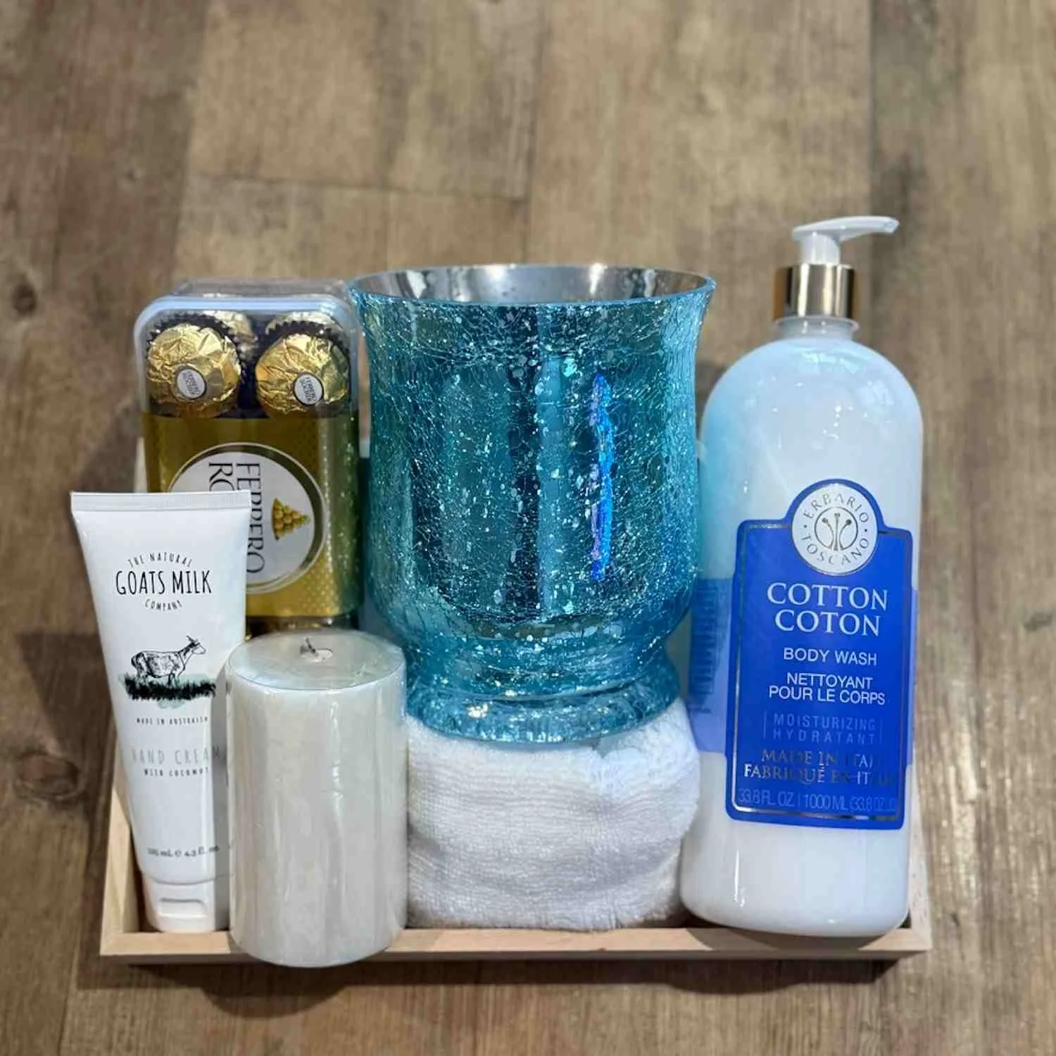 Self-Case gift hamper with Chocolates body Wash and Hand cream with a Candle and glass candle holder.