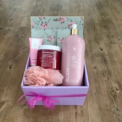 Luxury Peace & Pamper Gift in a lavender gift box with bath and body products, wrapped in cellophane with ribbons and bows