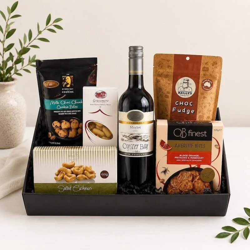 Elanora Gift Hamper with a bottle of wine cashew nuts, cookies, chocolate fudge, raspberry bullets and gourmet artisan crackers.