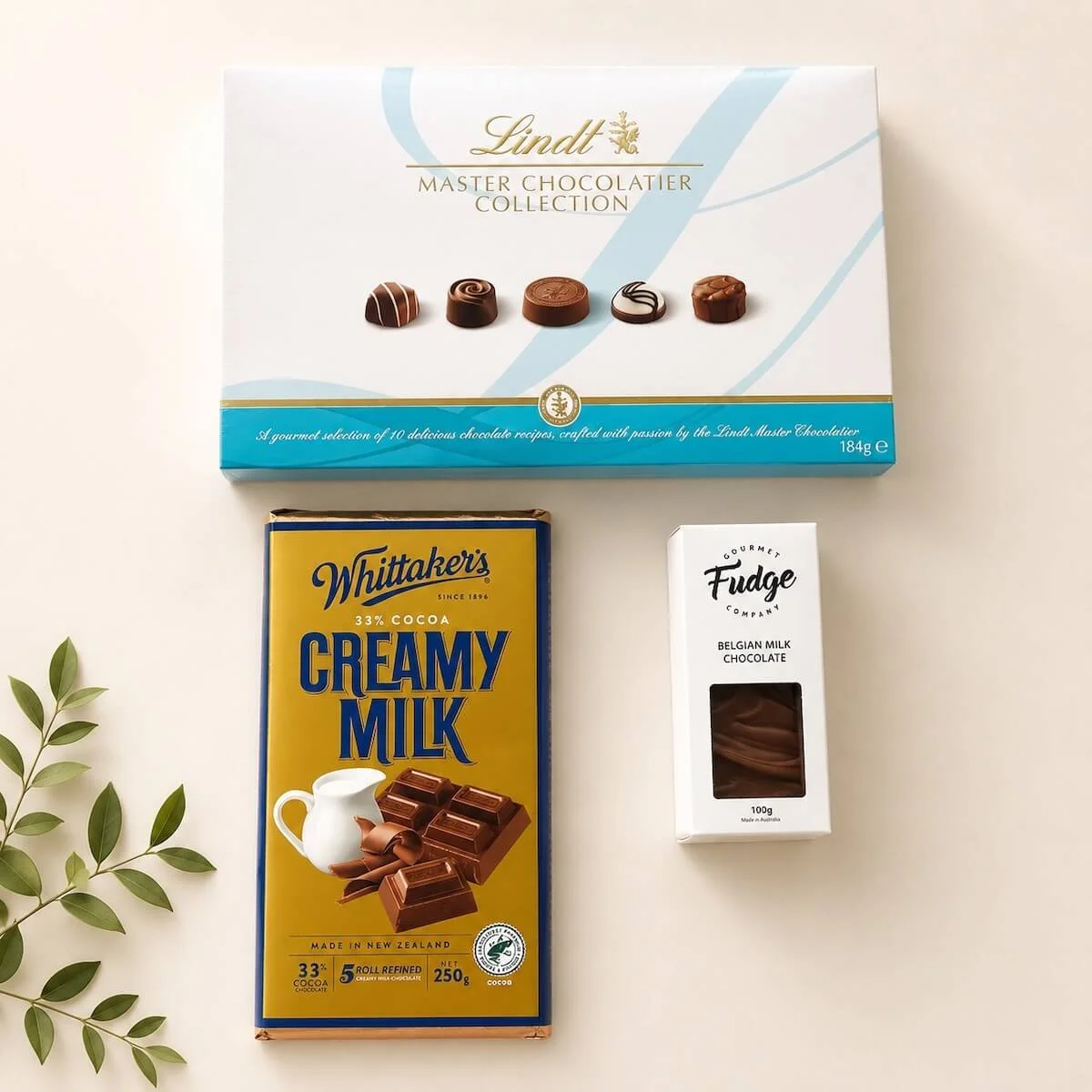 Chocolate tower chocolates. Lindt collection 184g, whittakers milk chocolate bblock 200g, and gourmet fudge 100g.
