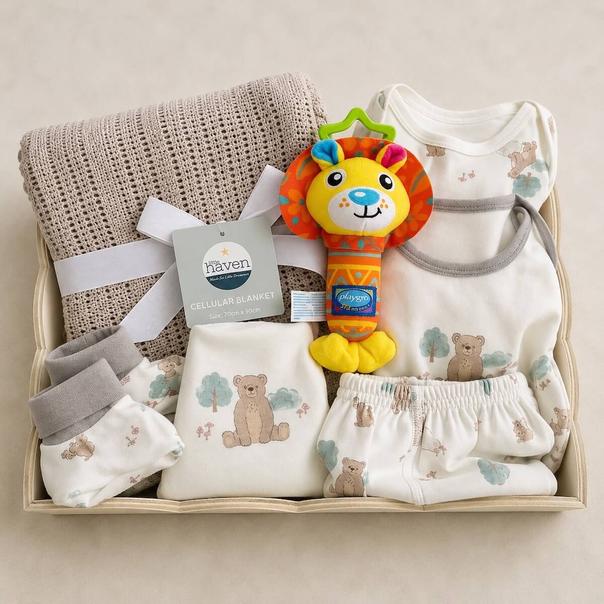 Baby gift hamper with a blanket 4 piece clothing set, toy in a beautiful basket.