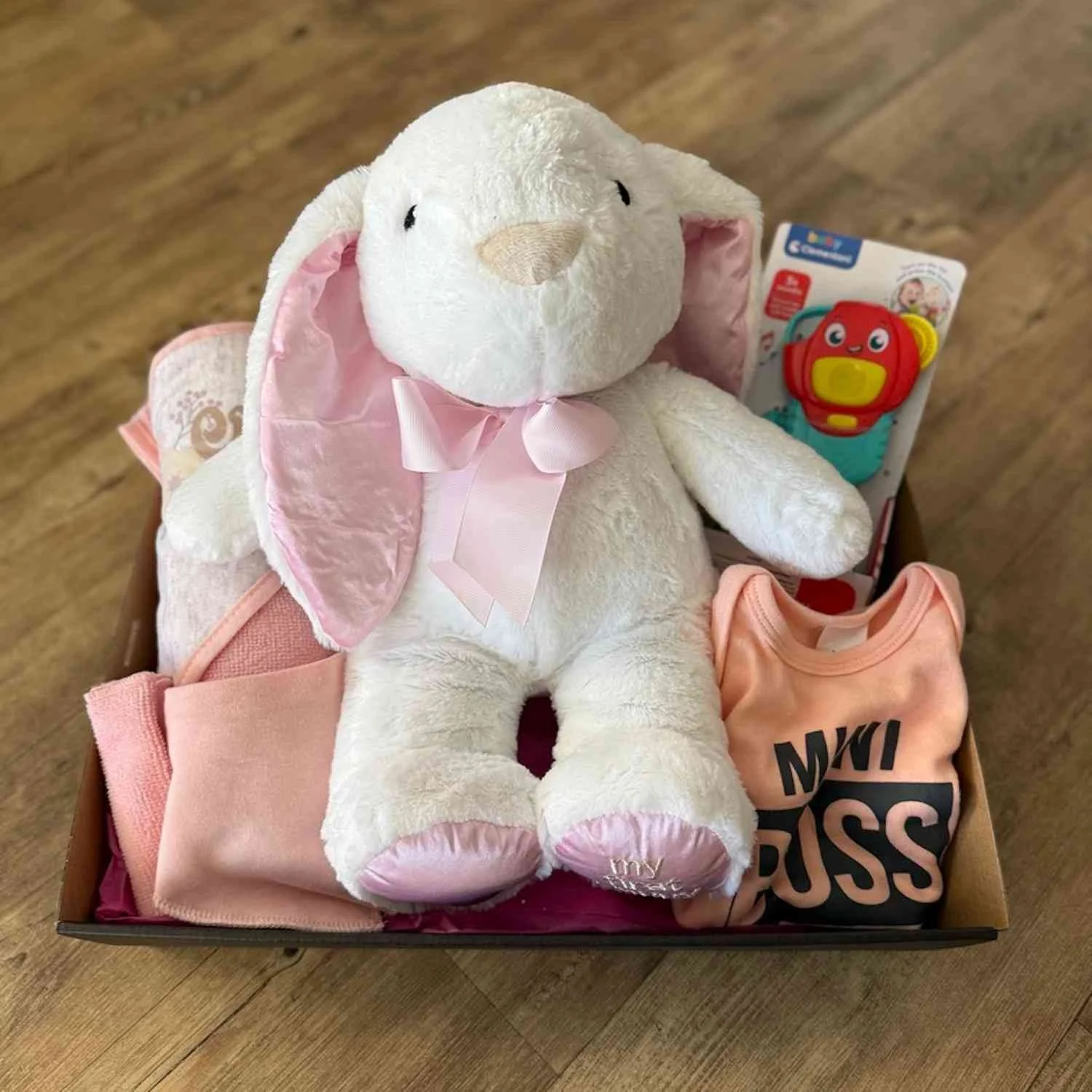 The Baby gift box with a Hooded Towel and Washer, Bandana bib, Body Suit, Rattle and a 28 cm sitting White and pink bunny.