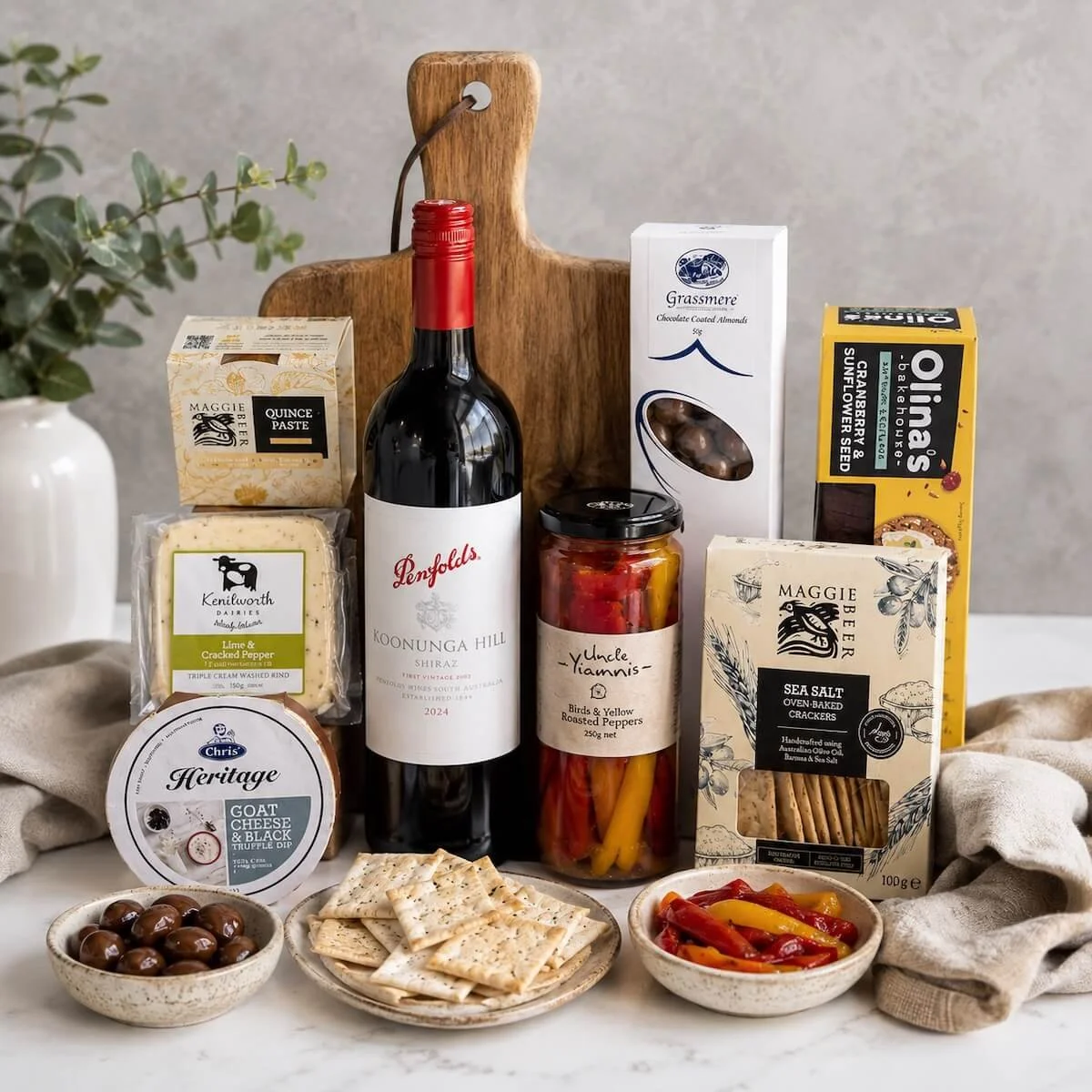 Gourmet cheese and wine gift hamper with Penfolds Shiraz, cheeses, crackers, quince paste, roasted peppers and chocolate treats.