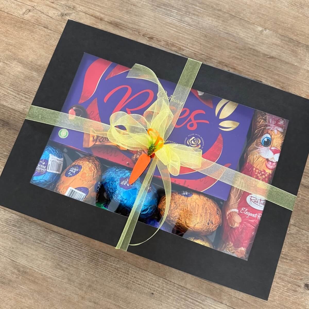 Easter Chocolate Gift Box with 380g Roses chocolates, chocolate Easter bunny and assorted Easter eggs in black window box with ribbon