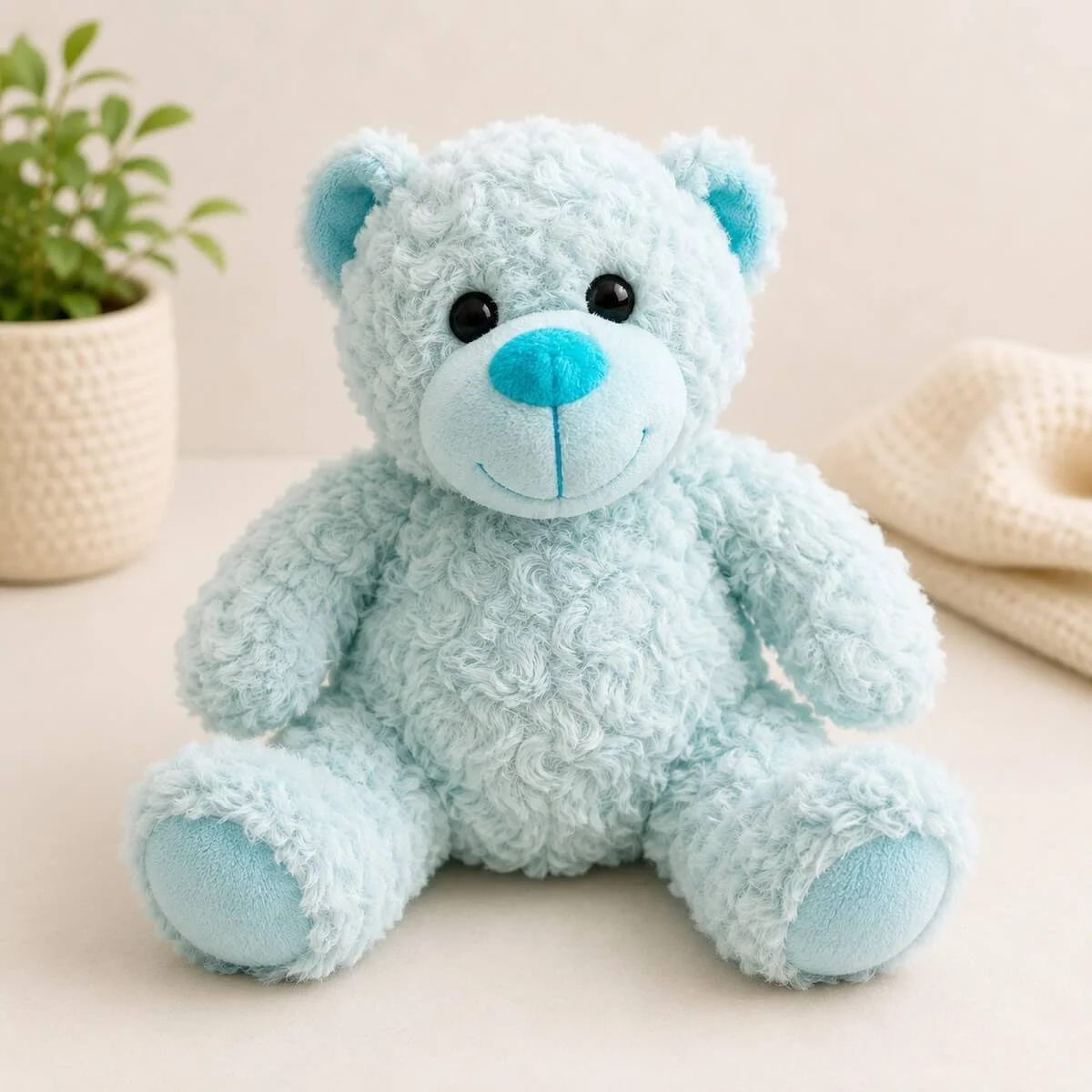 Blue teddy beach with curly fur making him really soft and cuddly. HKe also has two tones, with the nose and inside the ears a different colour.