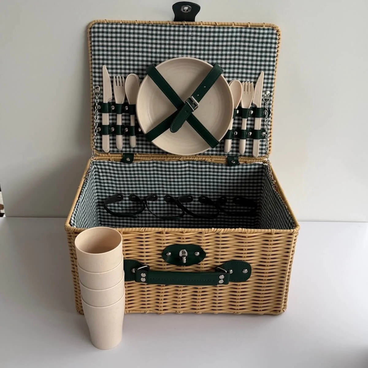 Empty plastic wicker picnic basket for four, 40 x 28 x 21 cm, with moss-green picnic blanket folded inside