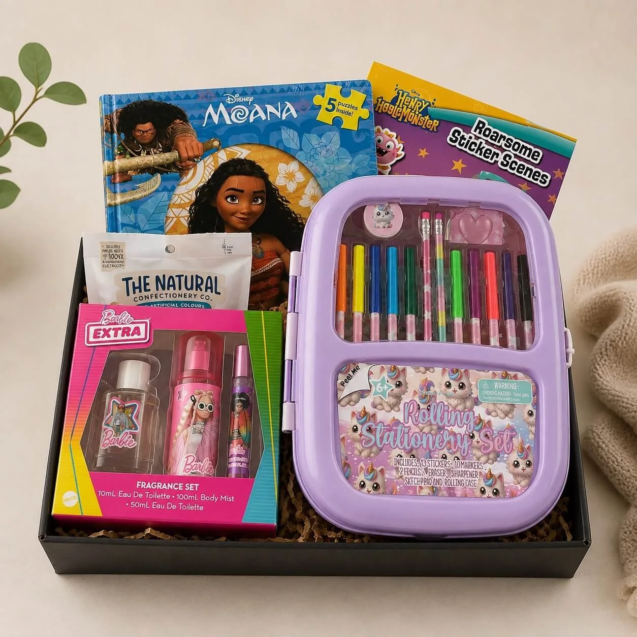 Girls gift hamper with a stationery set, Barbie fragrance gift set, Disney Moana puzzle book, sticker book and snake lollies. Same-day Gold Coast delivery.